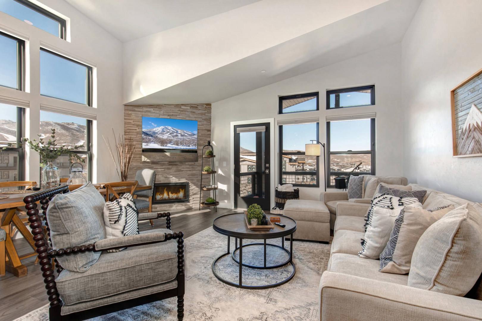 Cozy space with a fireplace, natural light, and outdoor views.