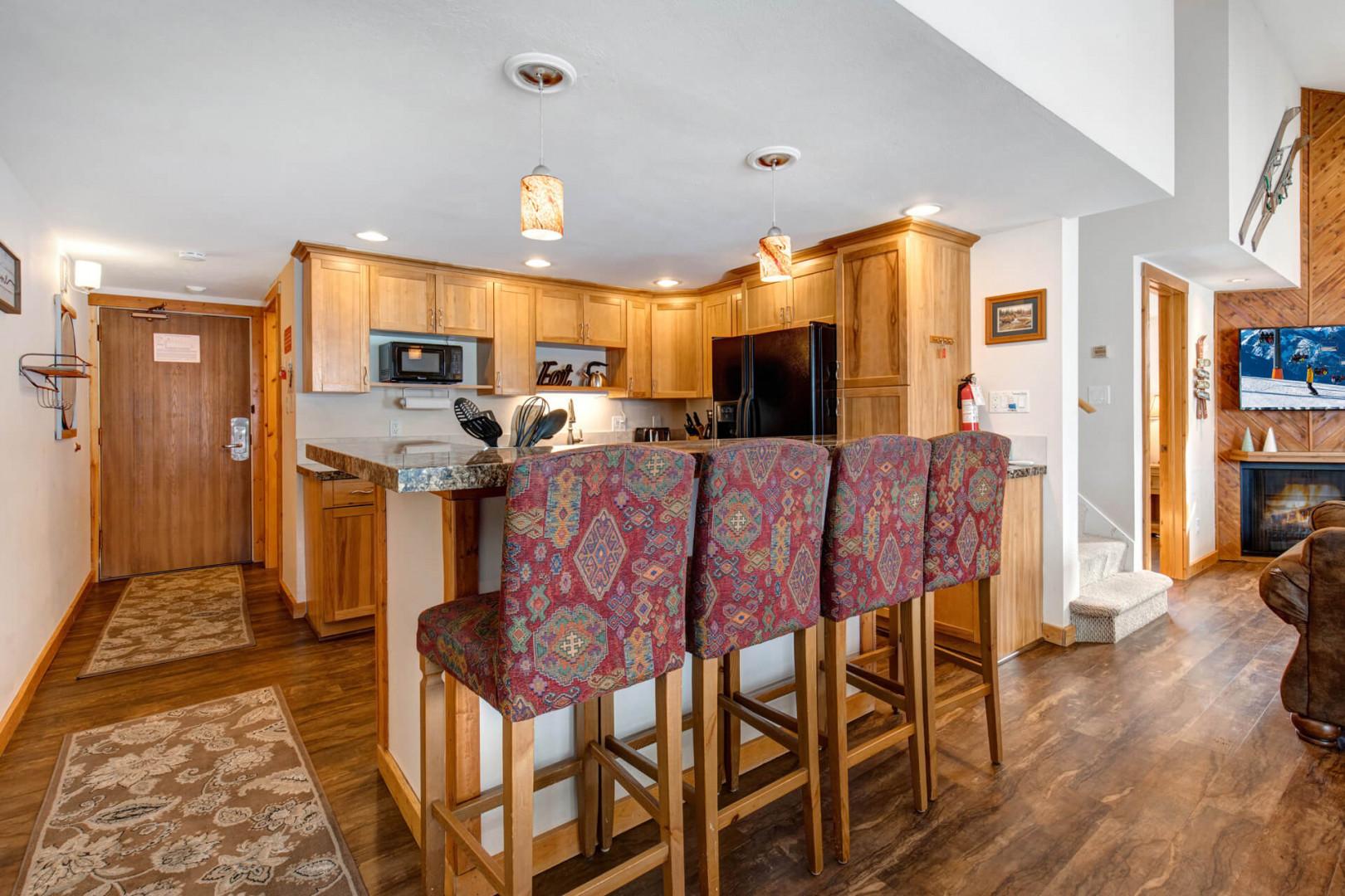 Cozy bar stools by the kitchen bar table, perfect for breakfast.