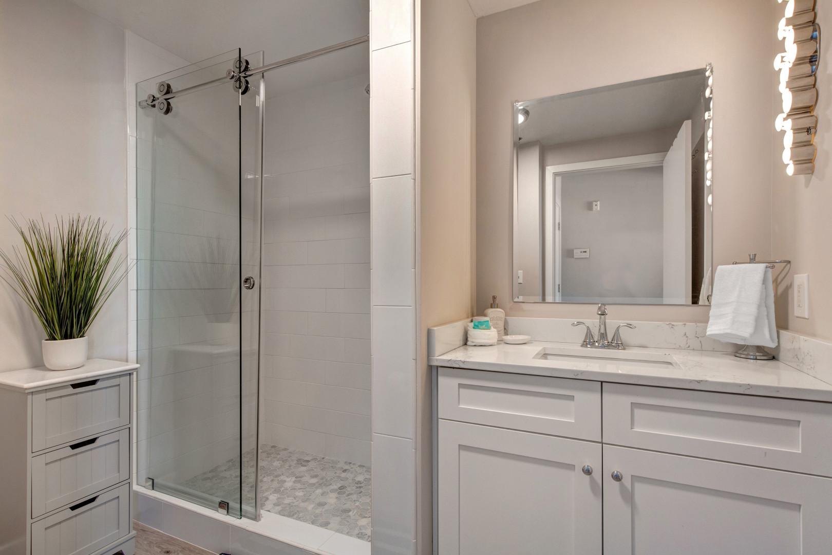 Stillwater 3067: Sleek sink and shower area with modern fixtures and clean design.