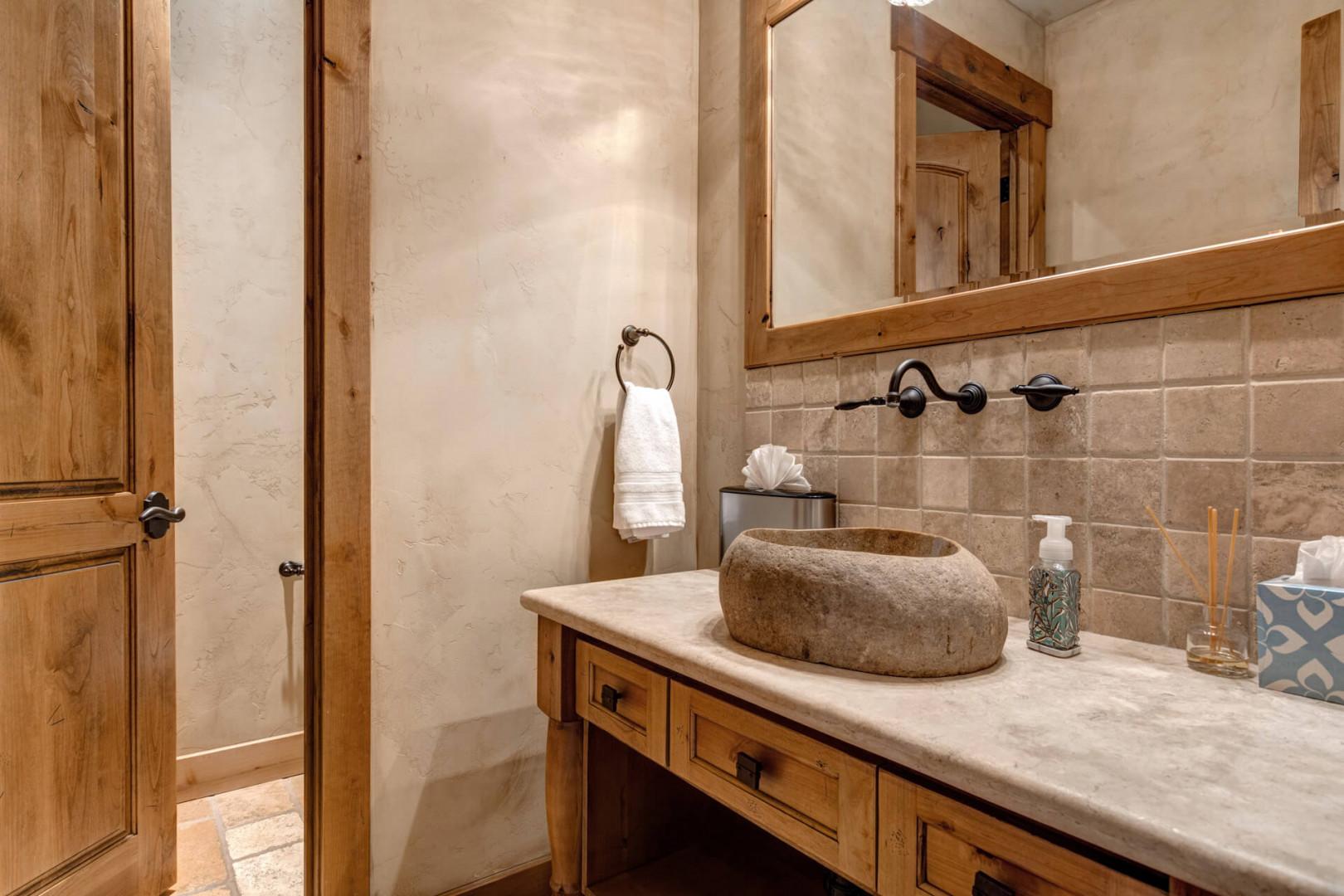 Reflective sink area with a sleek mirror, perfect for morning routines.