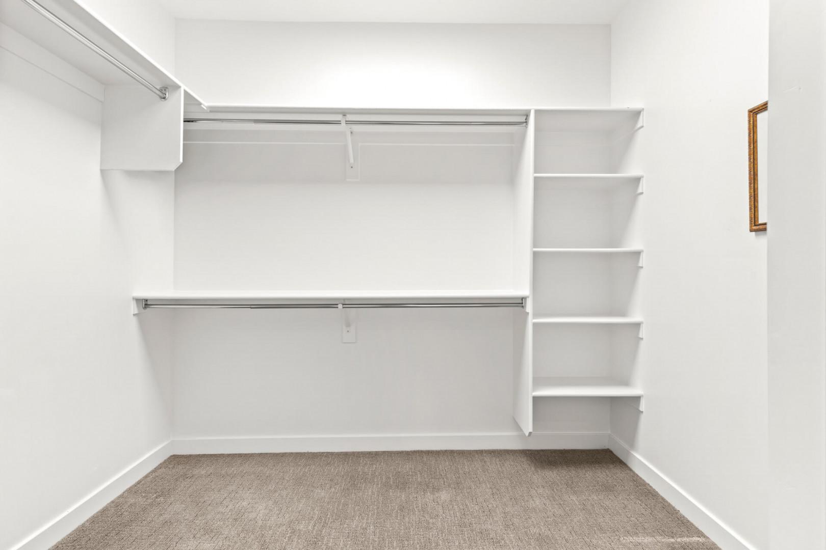 Your walk-in closet offers generous hanging space on dual rods and built-in shelving to keep everything organized and accessible during your stay.