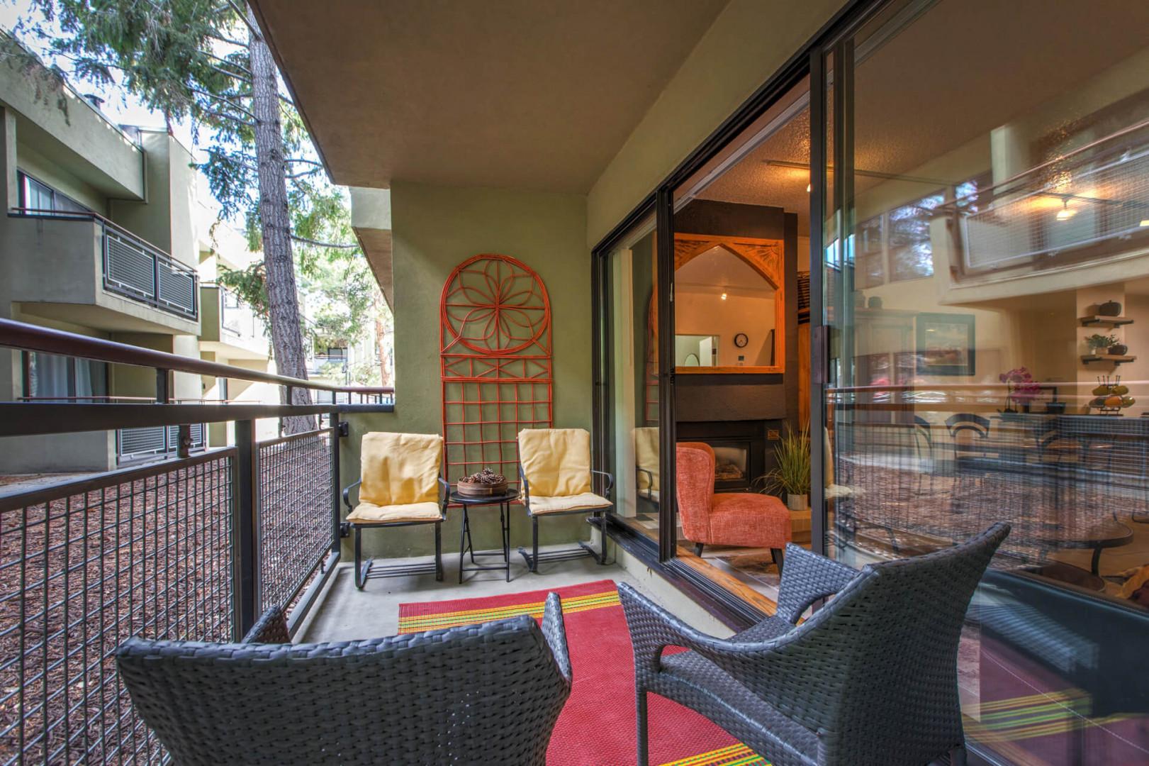 Outdoor Patio: "Inviting outdoor space with four chairs and a red carpet.