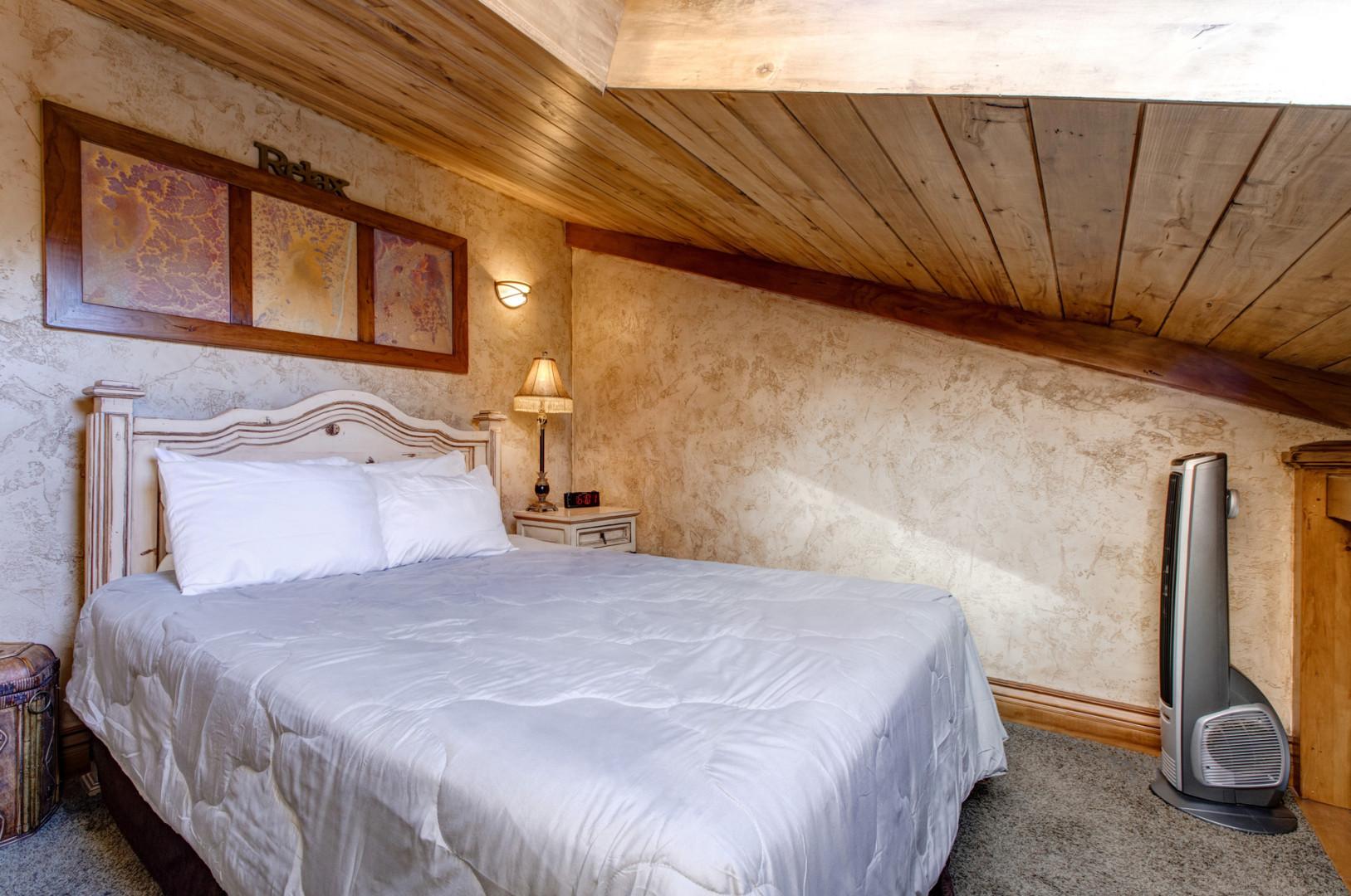 Loft: "Cozy queen bed tucked away under the eaves."