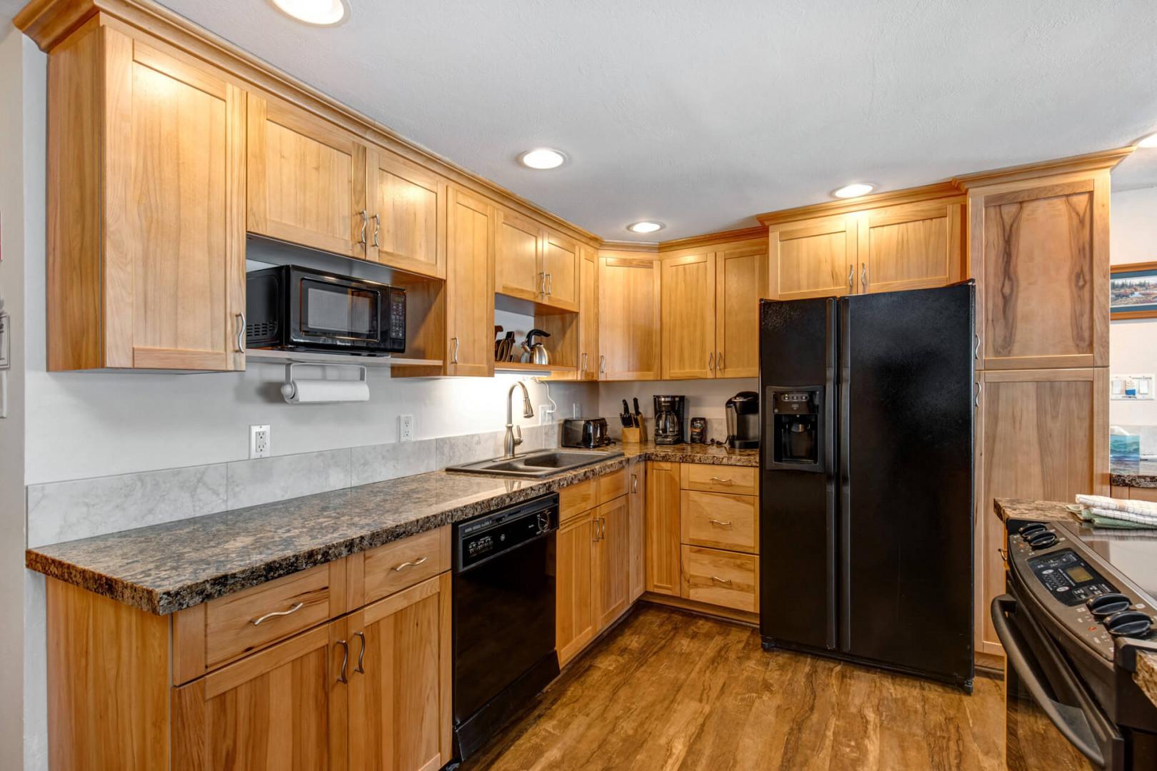 Modern appliances and sleek cabinets create a functional cooking space.