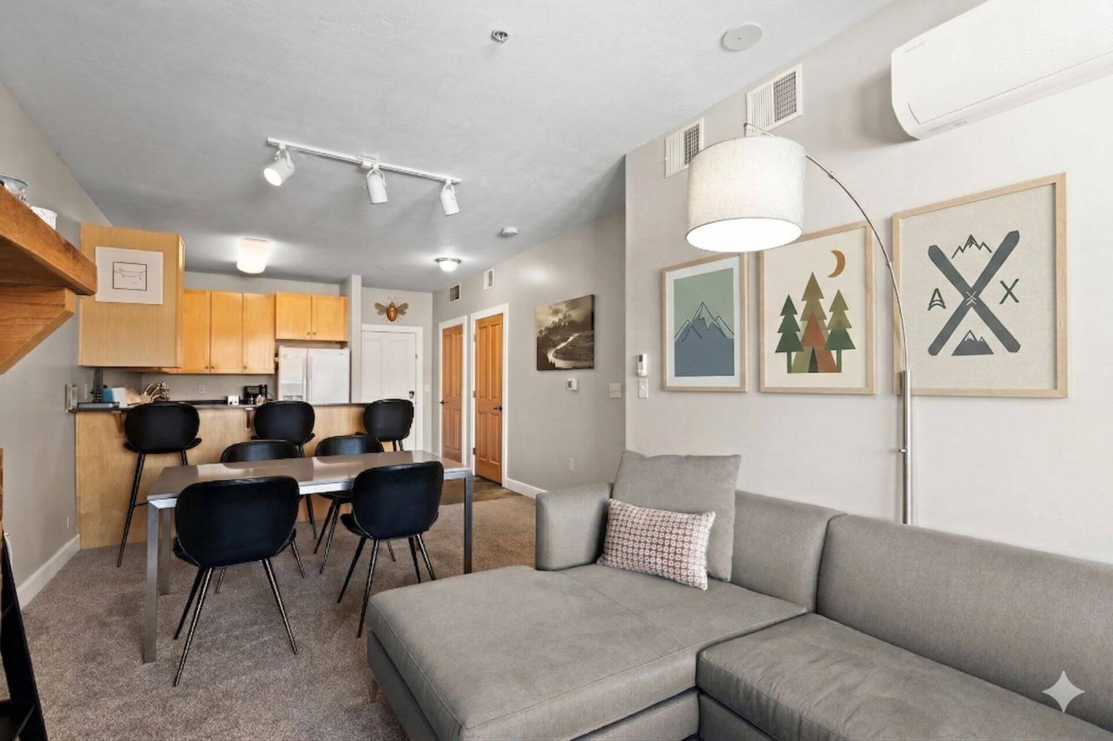 Unwind in your stylish open-concept space where the cozy living room flows seamlessly into a modern kitchen and dining area.