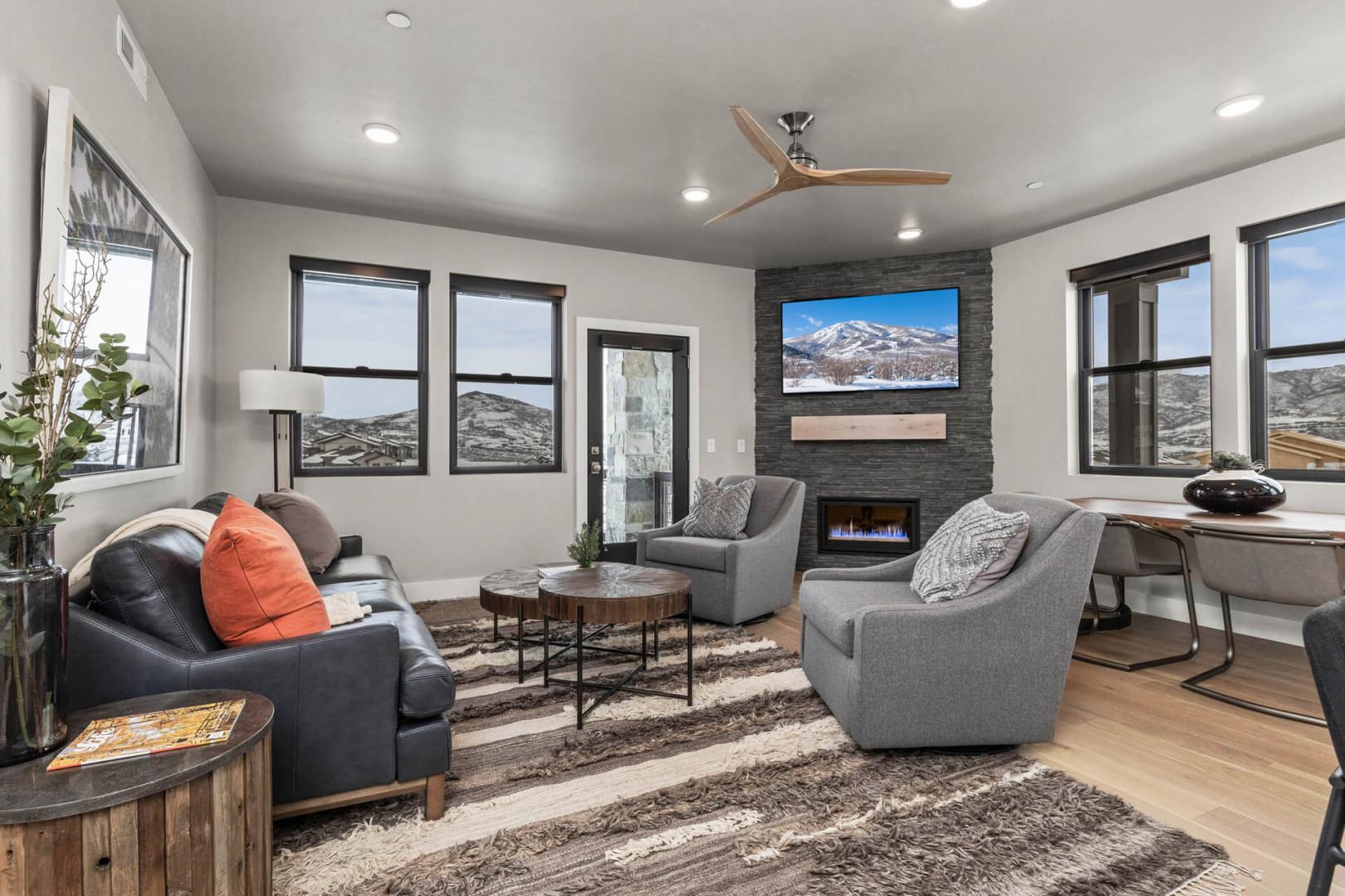 Living Room: "Cozy setup with fireplace, TV, and scenic views from the windows."