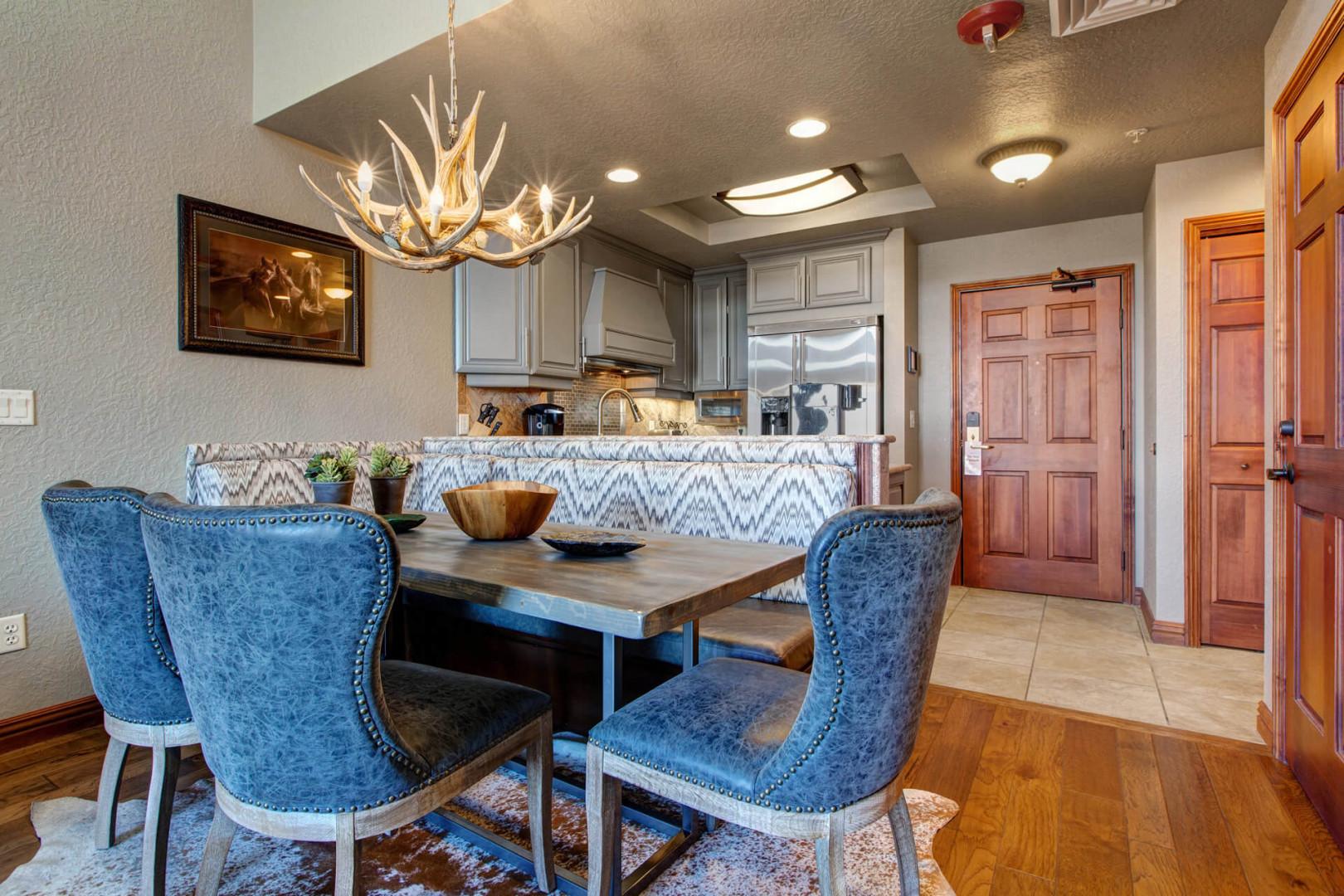 Cozy dining table sits near the kitchen, perfect for intimate meals.