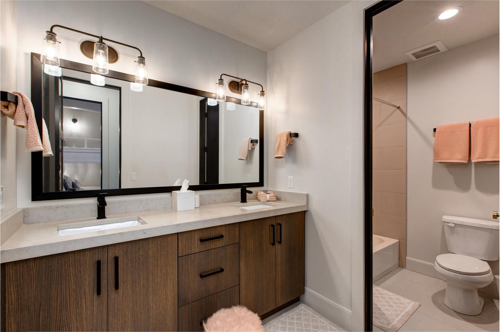 Jordanelle Estates 13201: Reflective sink area with a sleek mirror, perfect for morning routines.