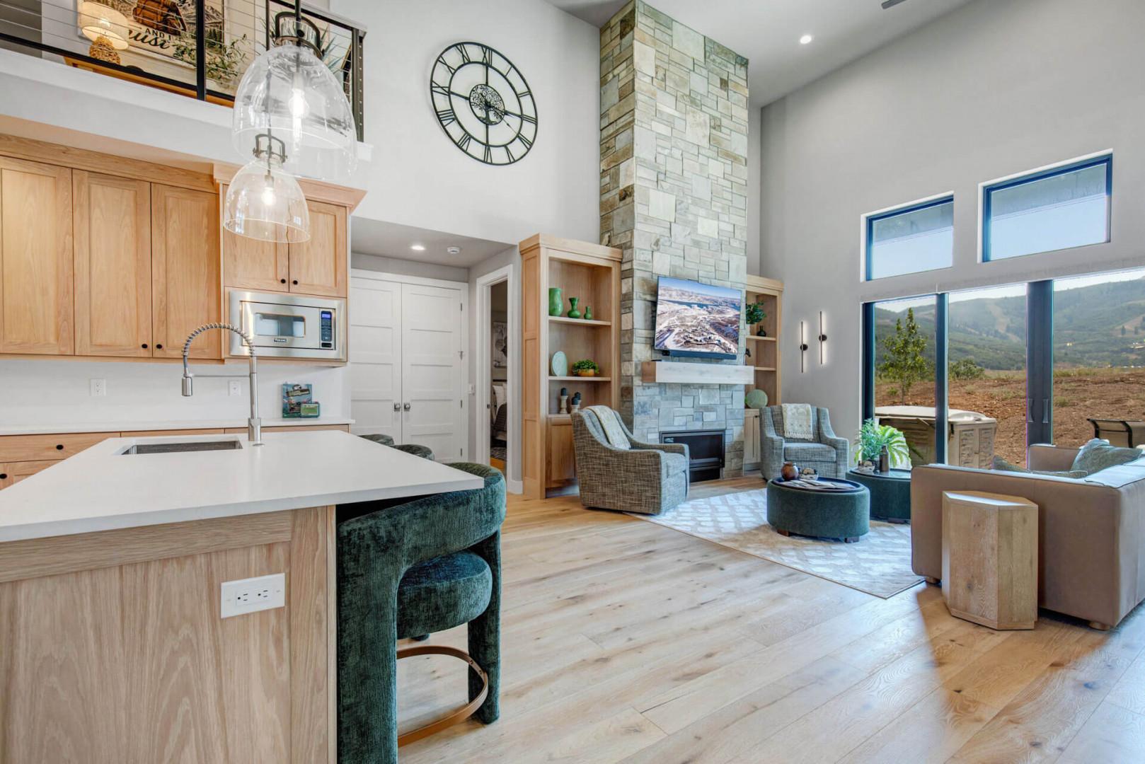 Step into your bright, open-concept retreat where high ceilings and expansive windows frame stunning mountain views. Warm wood tones and modern design create the perfect backdrop for your mountain getaway.
