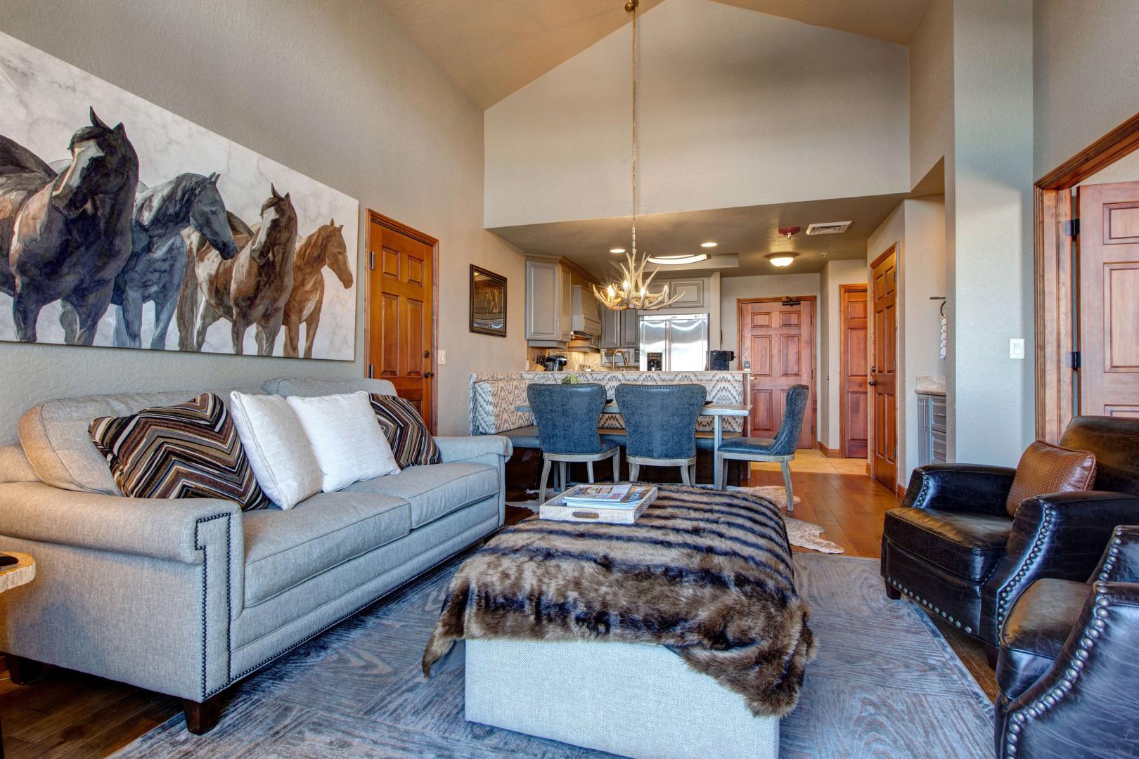 Cozy sofa set near dining table, with a peek of the bedroom.