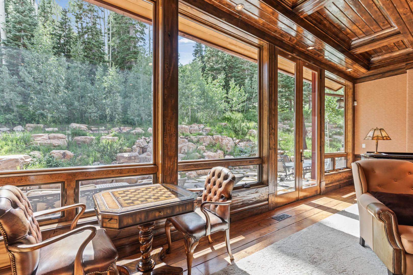 Nature's embrace through full-size windows, a tranquil haven among trees.