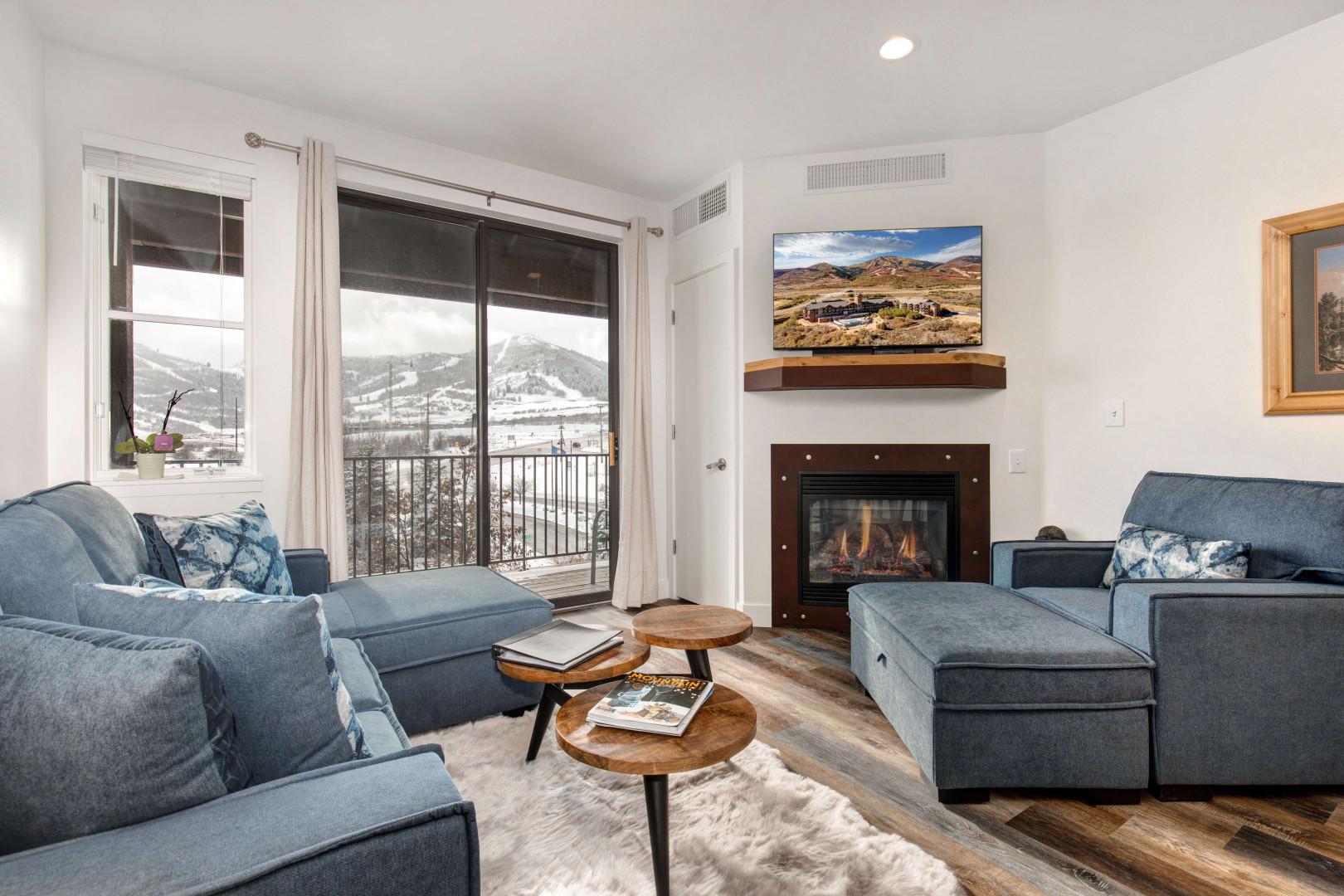 Stillwater #3011_06: Cozy sofa set by the fireplace, overlooking the serene balcony view.