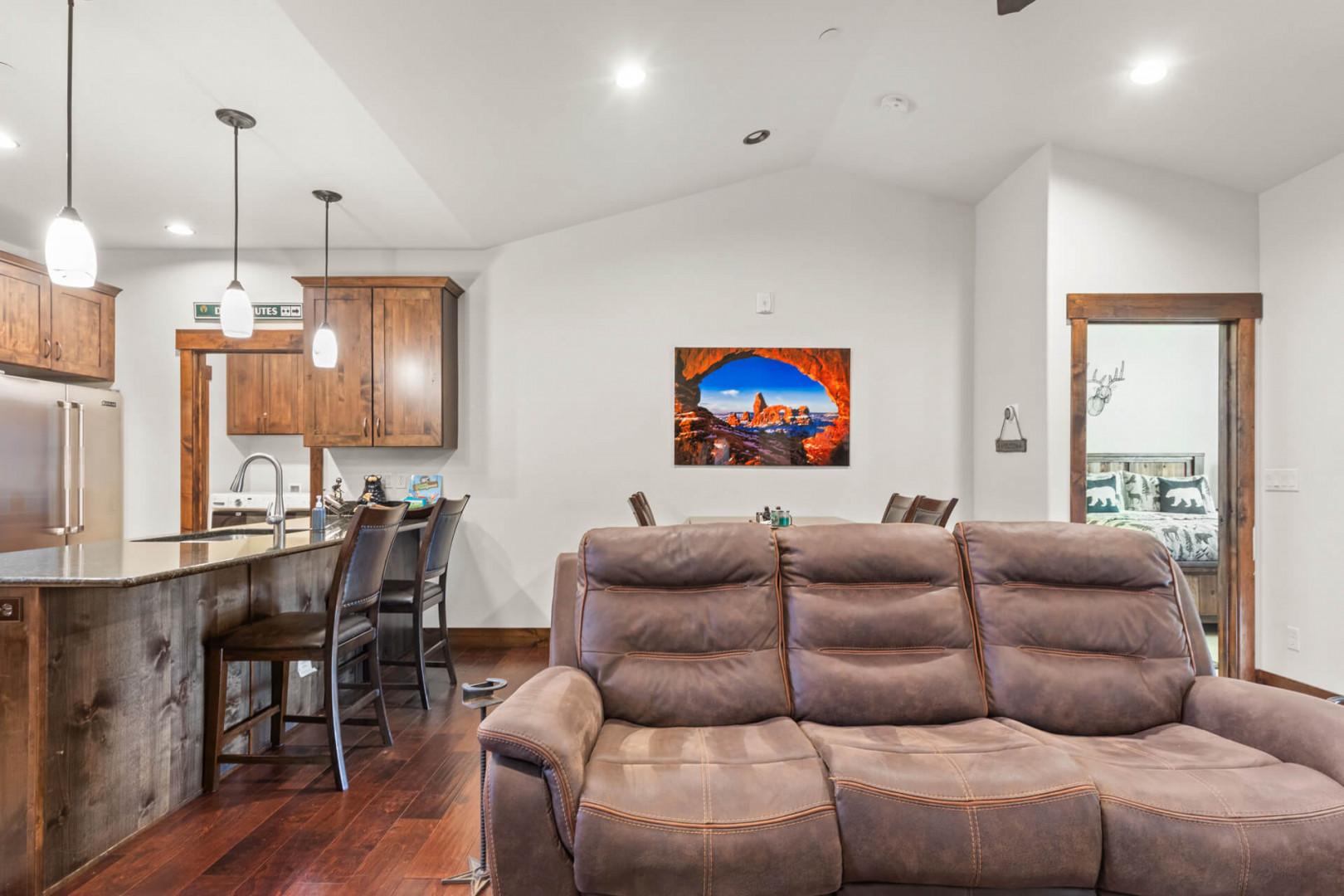 Unwind in your spacious open living area where rustic wood meets modern comfort, perfect for relaxing after mountain adventures.