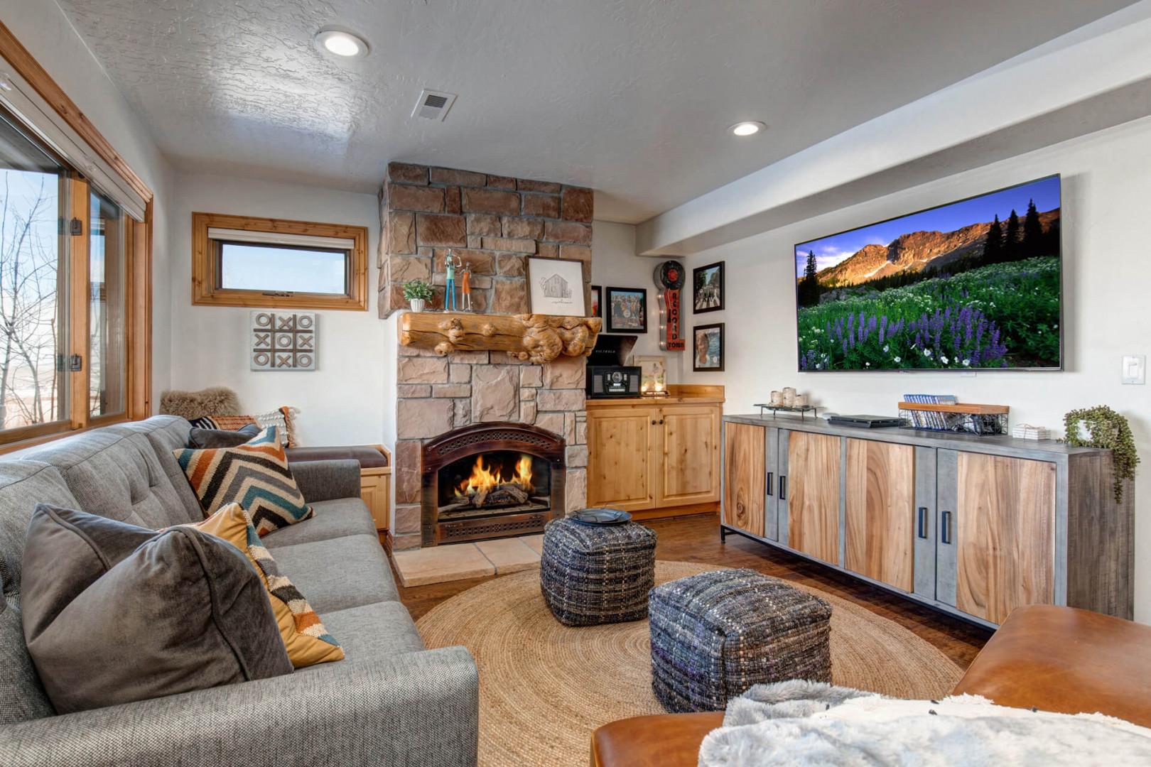 Bear Hollow 5534B: Indulge in the utmost comfort of our king sofa bed, surrounded by a warm fireplace and a large TV for endless relaxation and entertainment