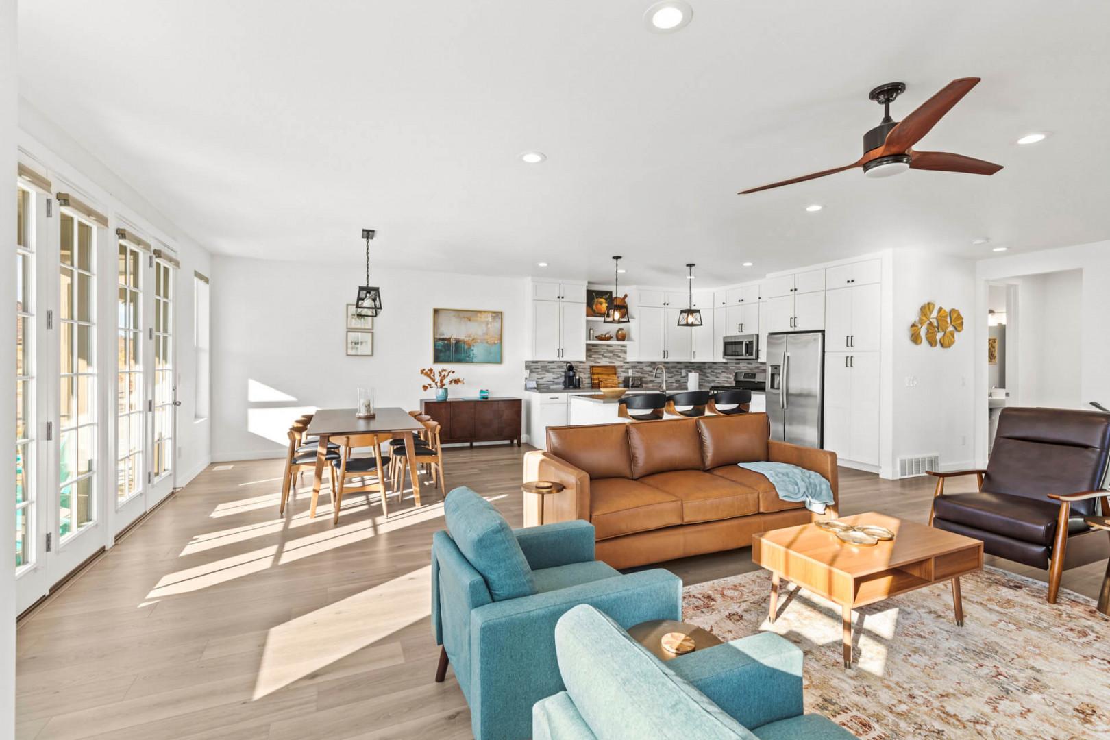 Sink into plush seating and soak up the natural light streaming through floor-to-ceiling windows. This open-concept living space flows seamlessly from cozy lounge to dining and kitchen—your home away from home.