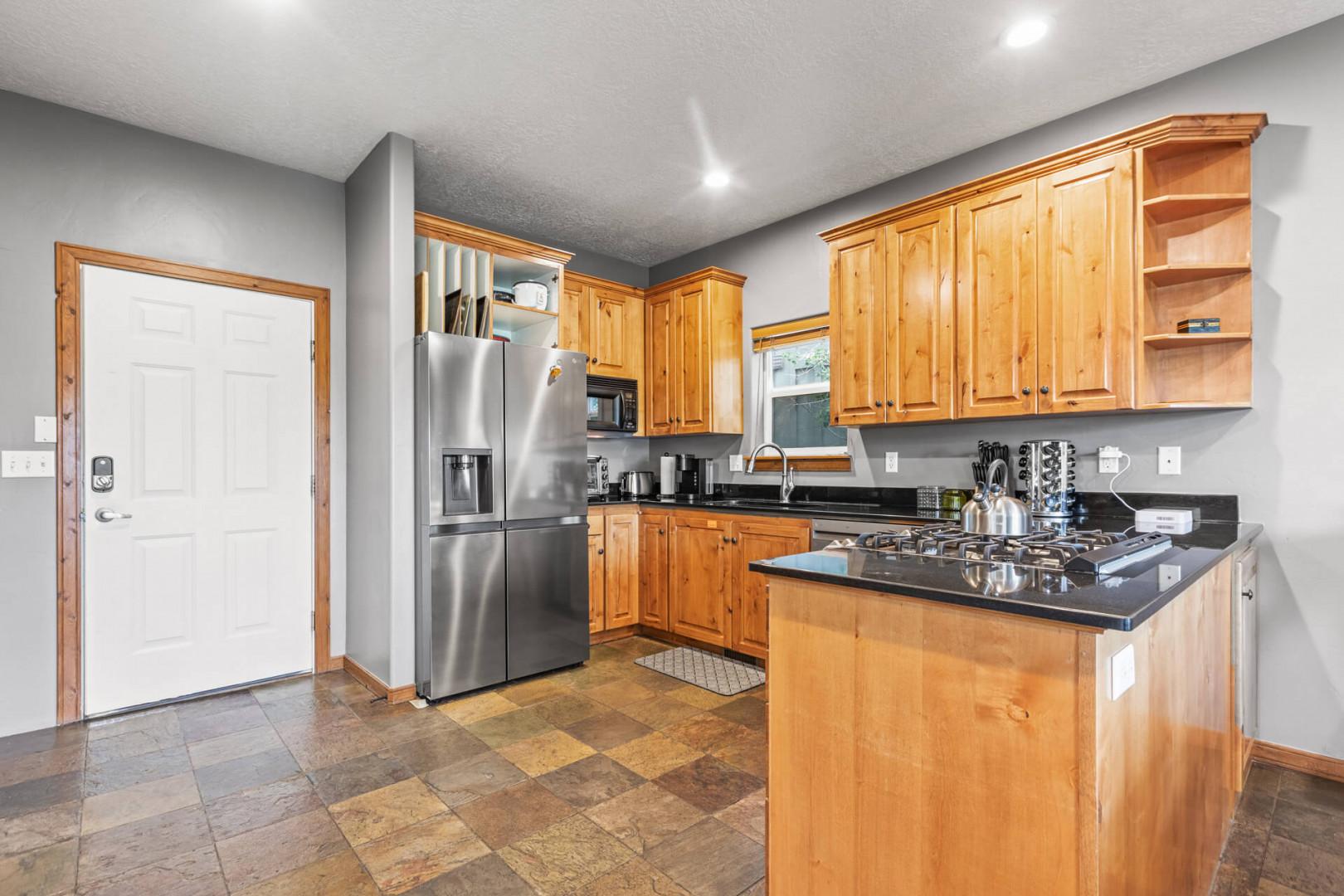 Bear Hollow Village 5458: The natural wood cabinets and sleek granite countertops provide plenty of storage and workspace.