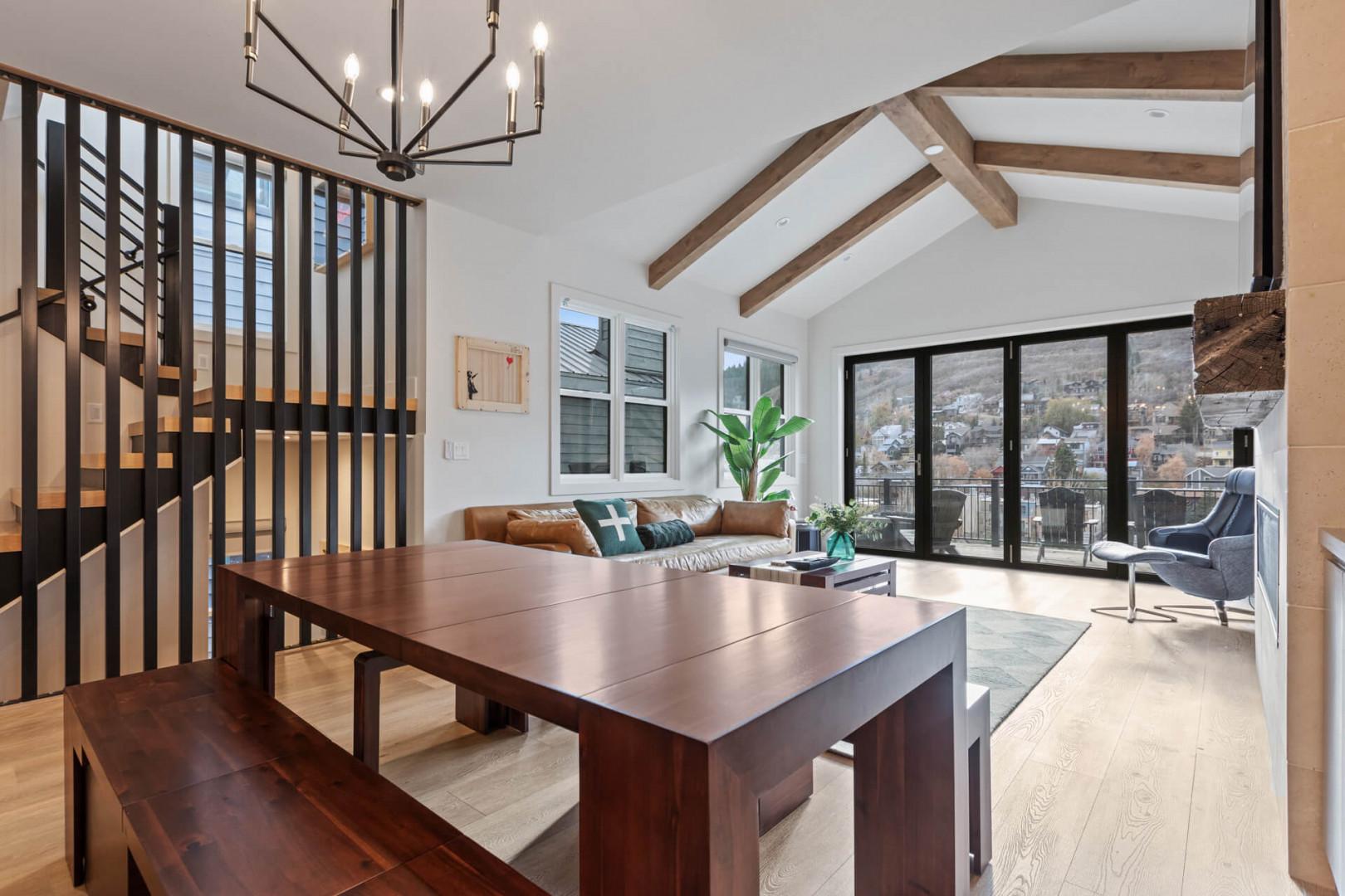 Elegant chandelier illuminates the stylish dining table setting.