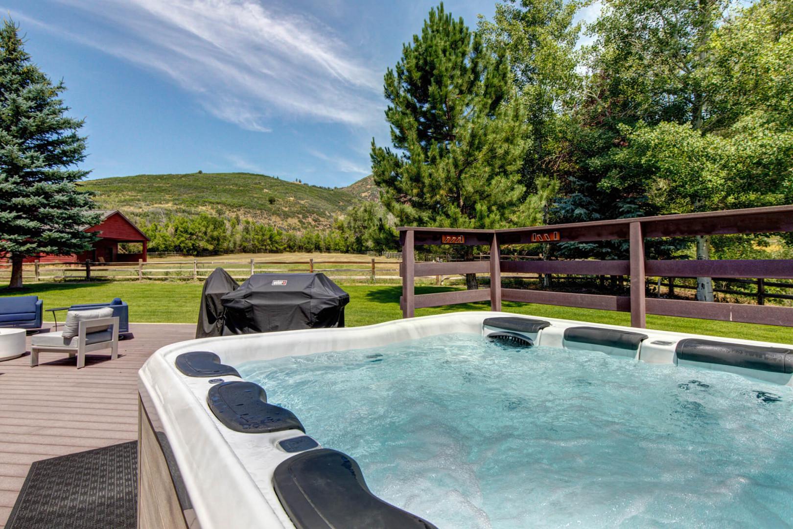 "Relax in the hot tub with outdoor seating and grill.