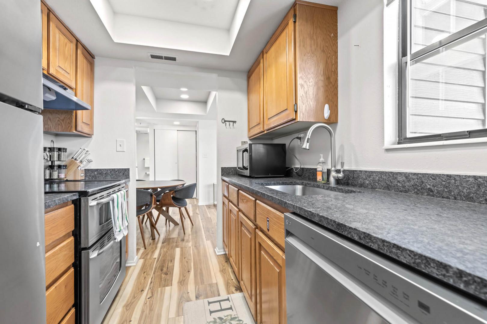 Powderwood 12N - Modern appliances and ample storage in sleek kitchen design.