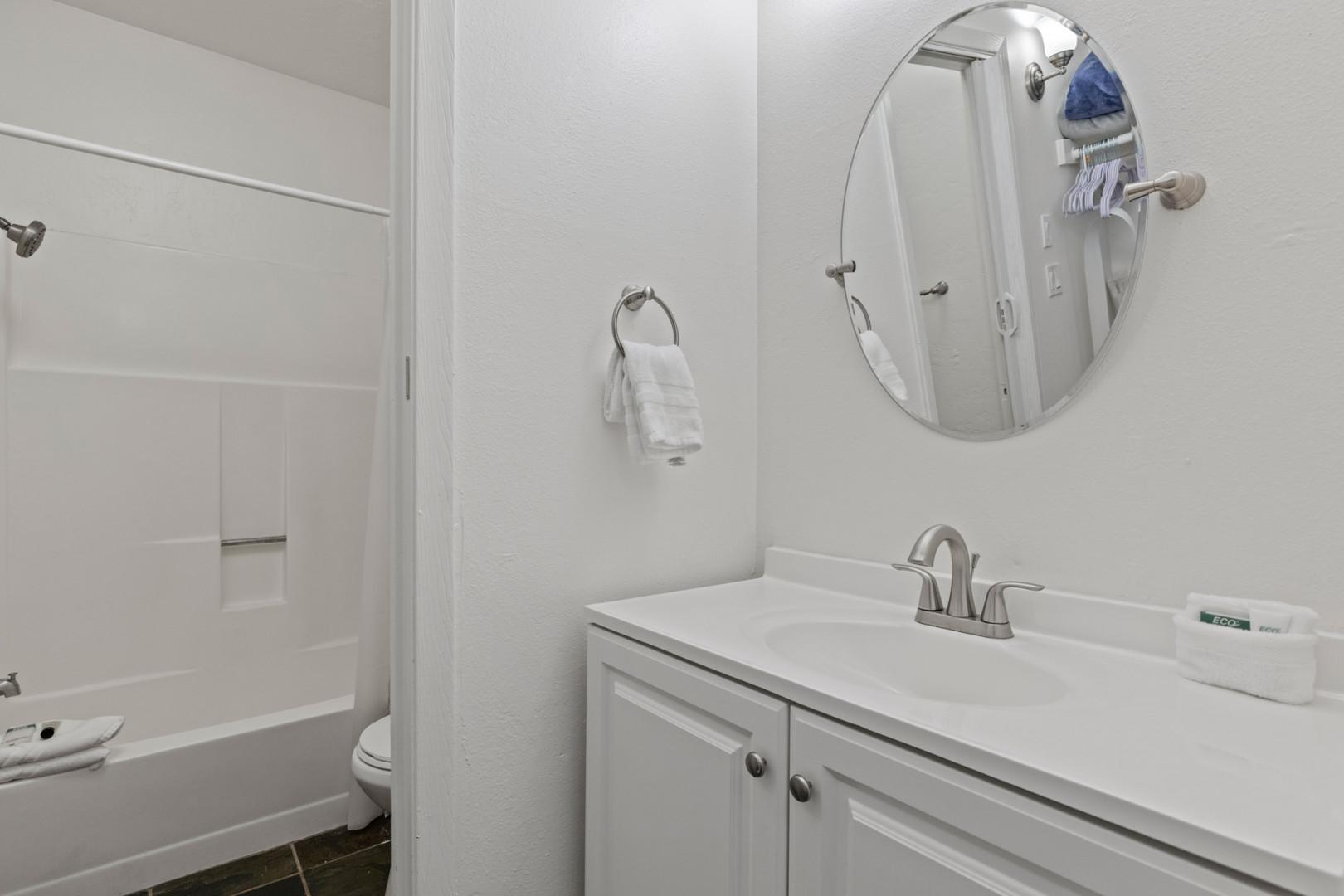 Reflective sink area with a sleek mirror, perfect for morning routines.