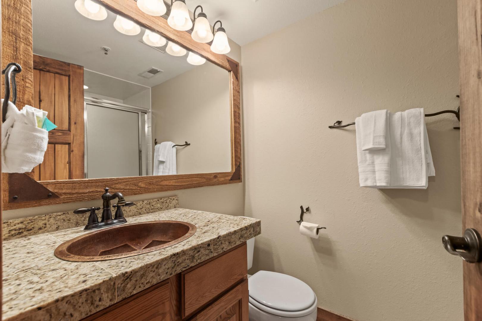 Powderwood 11C: Clean sink and toilet in a well-lit space.