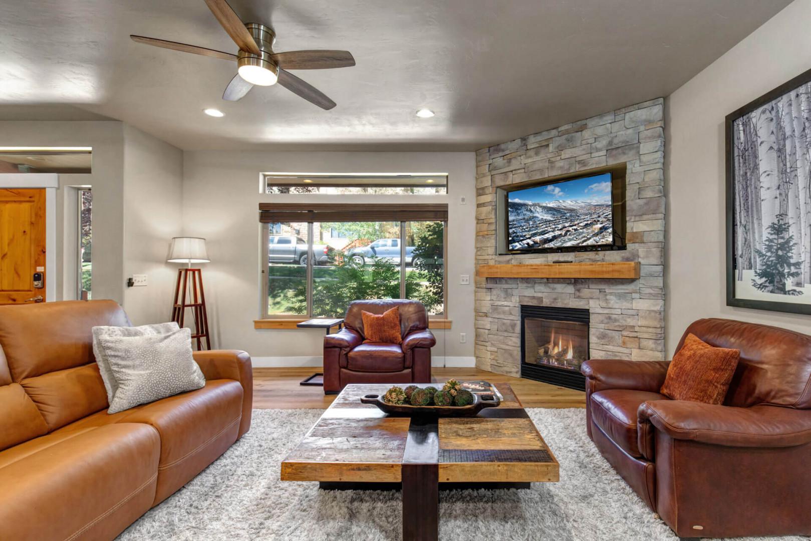 Sink into rich leather chairs by the stone fireplace, where mountain views through large windows create your perfect retreat.