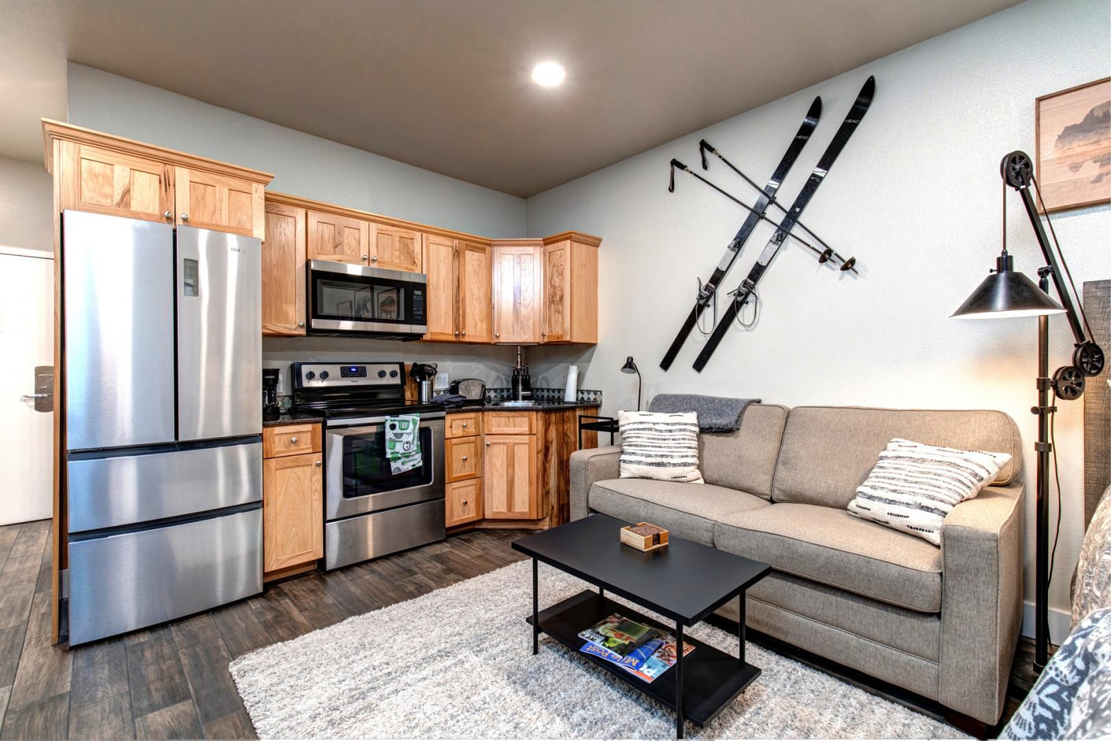 Cozy sofa next to a sleek kitchen, perfect for relaxing evenings.