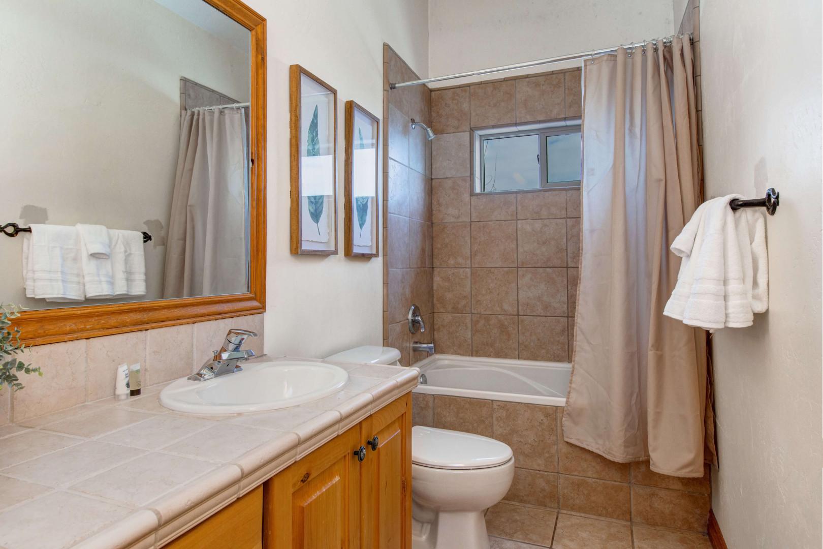 Bear Hollow 5478: Sleek sink, mirror, toilet, and convenient tub shower combo.