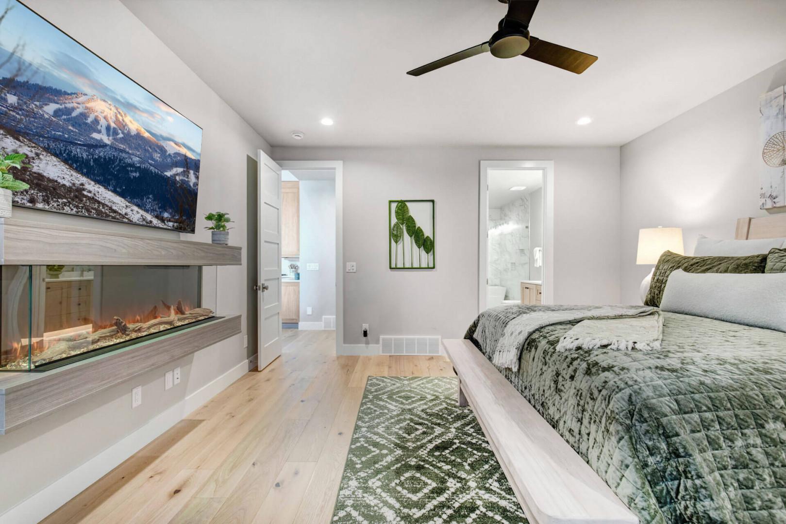 Unwind in your serene bedroom suite with a cozy fireplace and private ensuite bath. Soft lighting and modern comfort create the perfect retreat after a day of mountain adventures.
