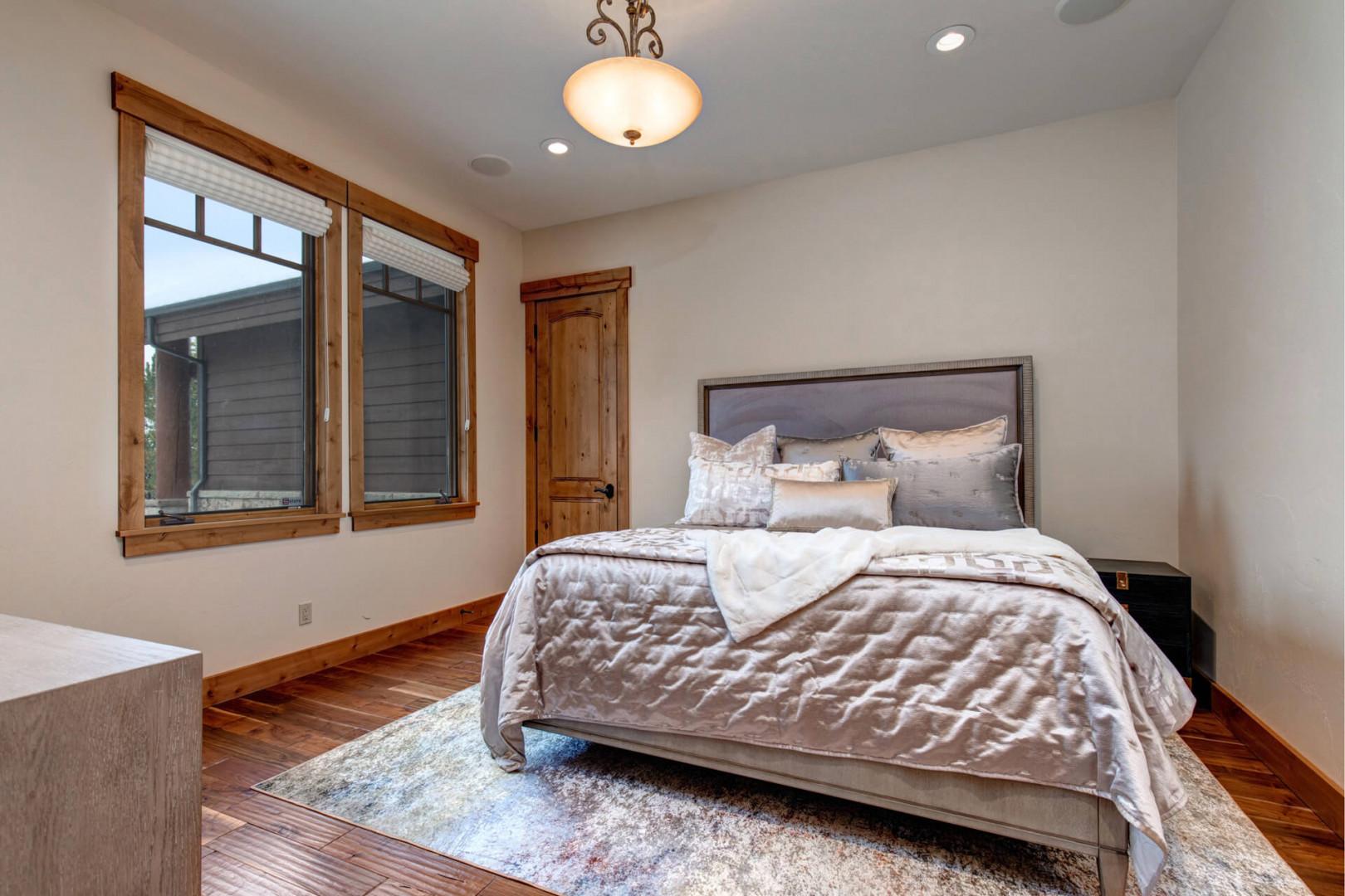 Cozy bed bathed in natural light from beautiful windows.