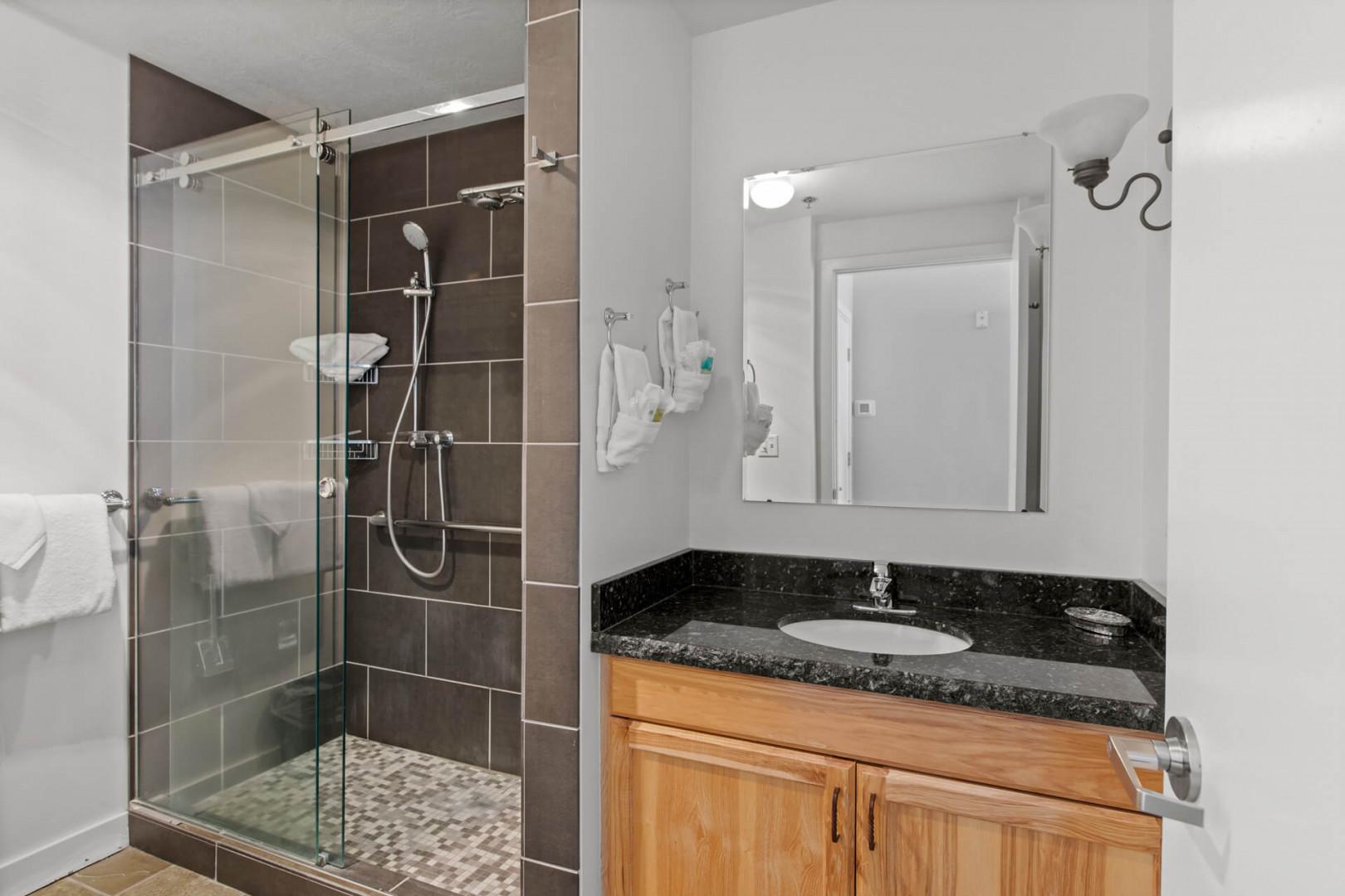 The Mason at Stillwater 2013: Sleek sink, mirror, and shower in modern design.