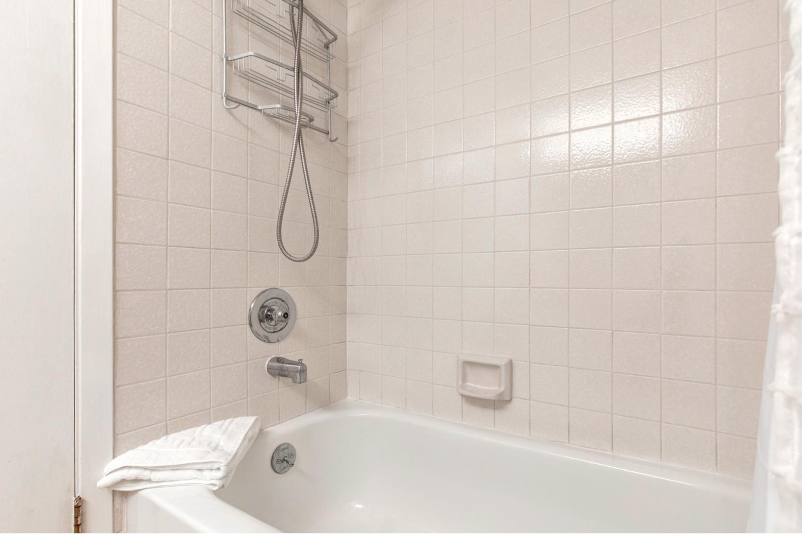 Powderwood 7B: Relaxing soak awaits in this convenient tub shower combo.