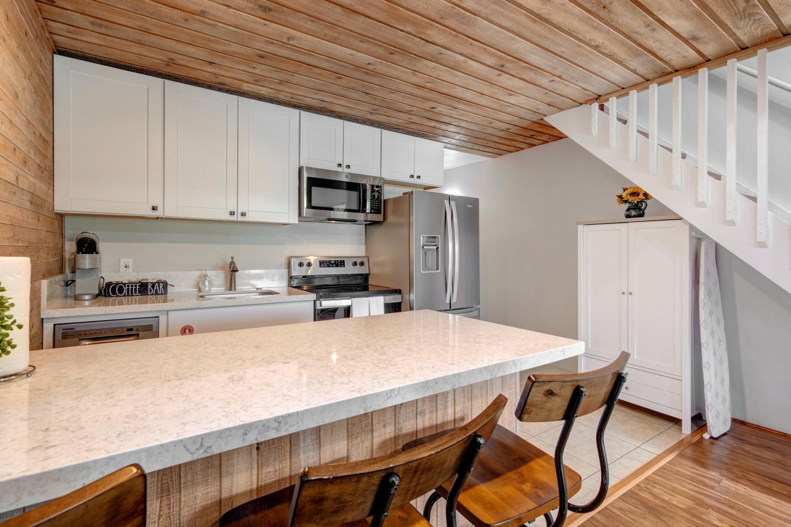 Bar stools at the kitchen top with a view of the area.