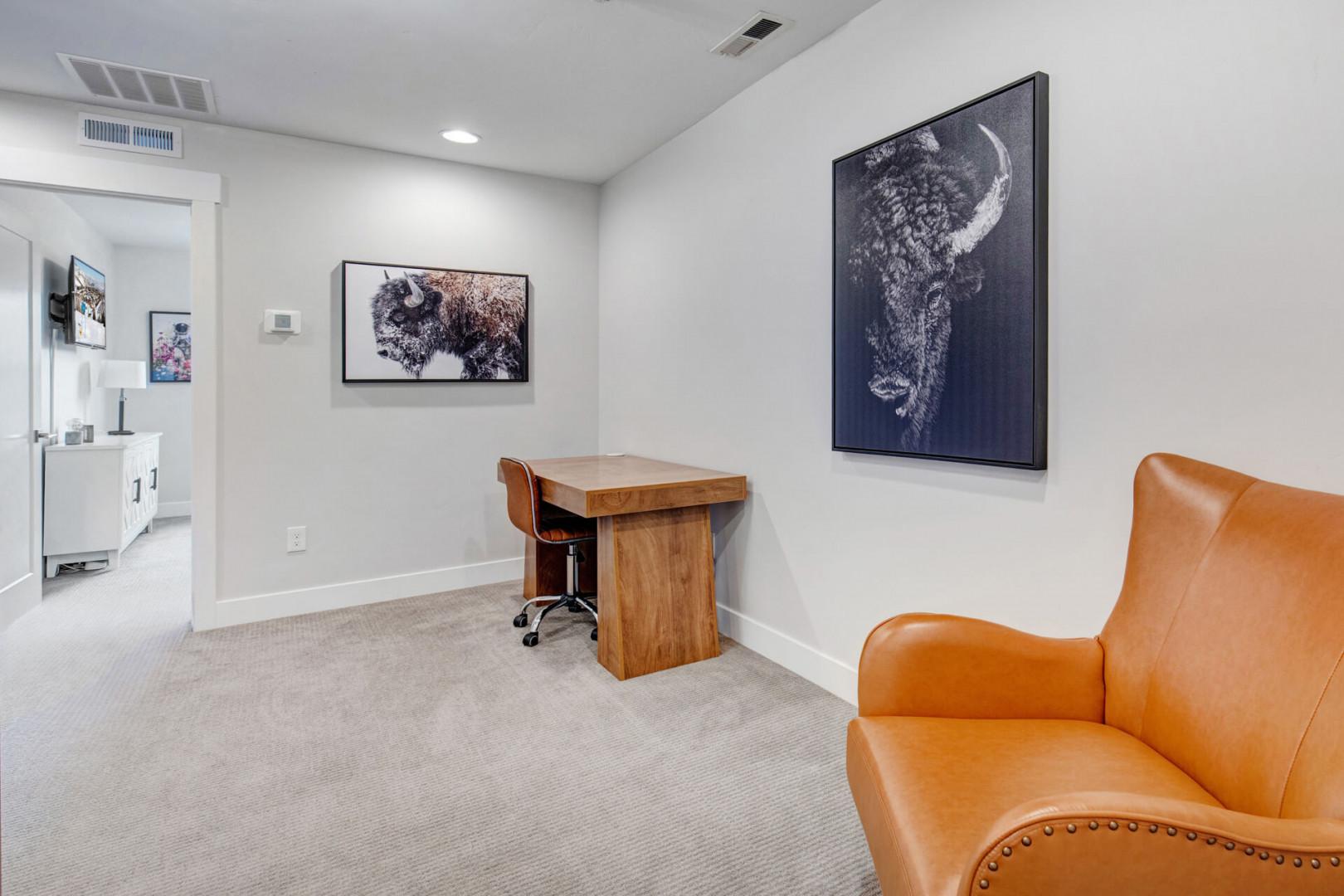 Your own quiet workspace awaits with a warm leather chair, sturdy desk, and inspiring artwork—perfect for catching up on emails or planning your next adventure.