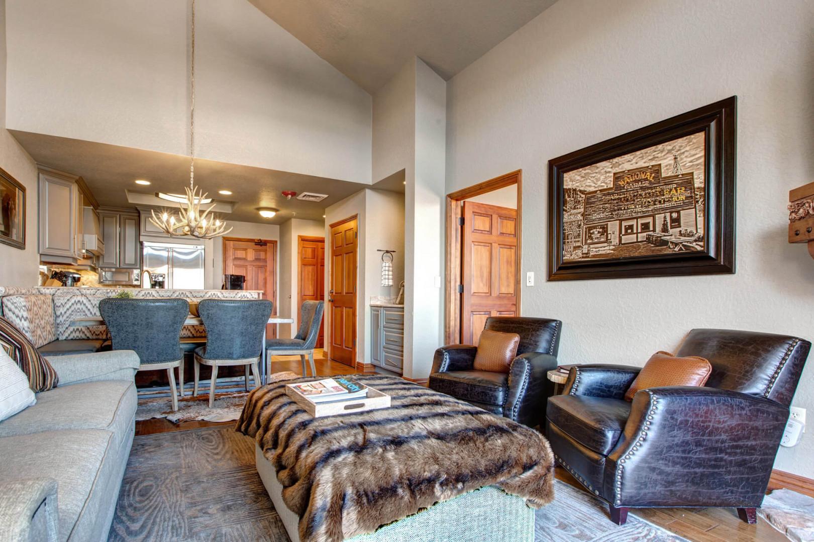 Cozy sofa set near dining table, with a peek of the bedroom.