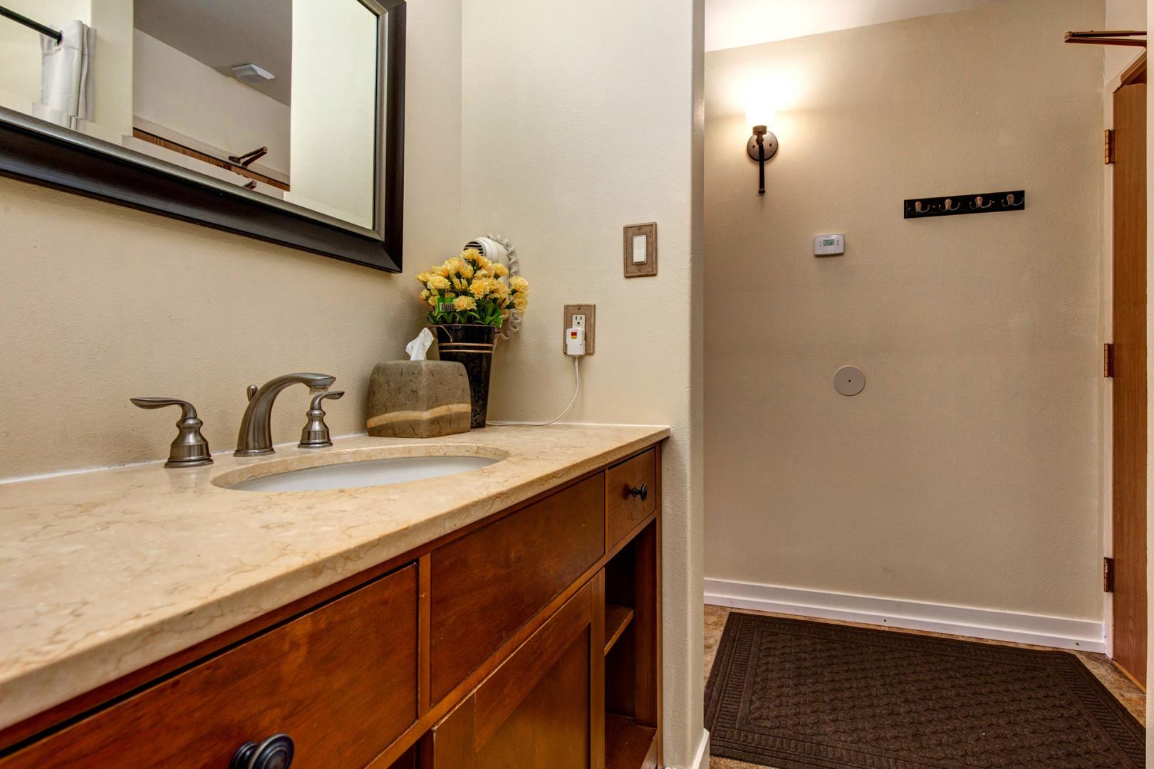 Sleek sink, mirror, toilet, and shower in modern design.