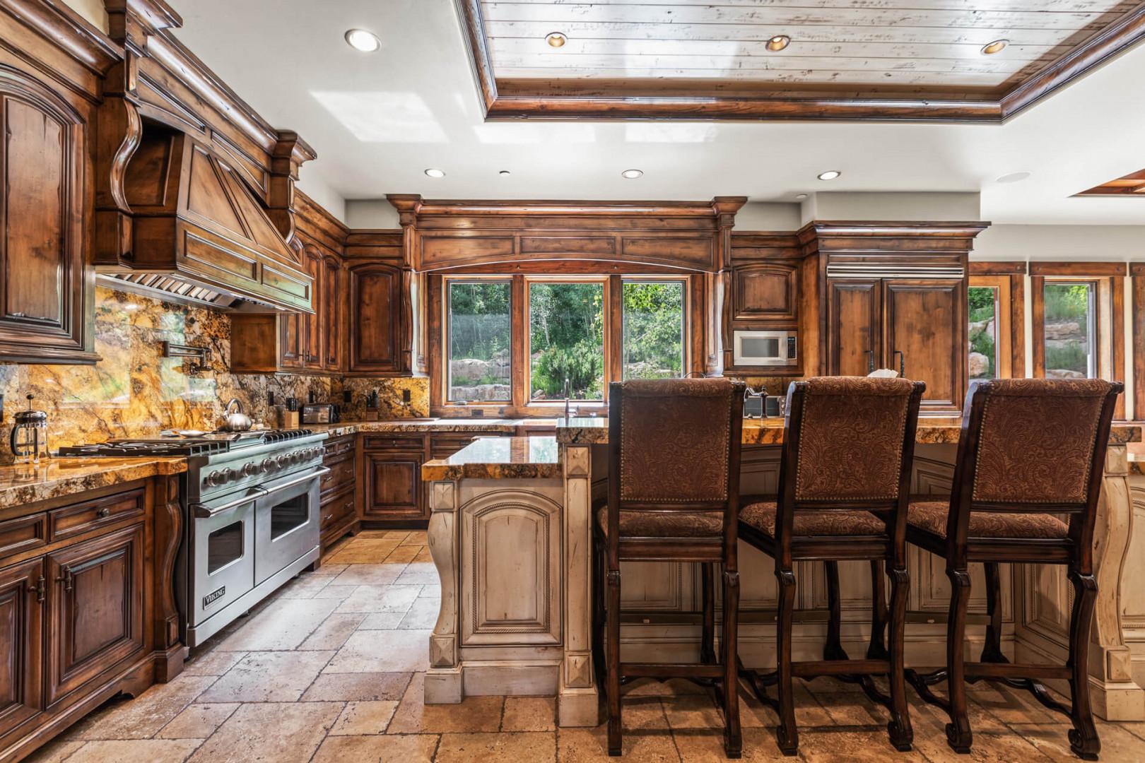 Cozy kitchen with bar table and dining area for family gatherings.