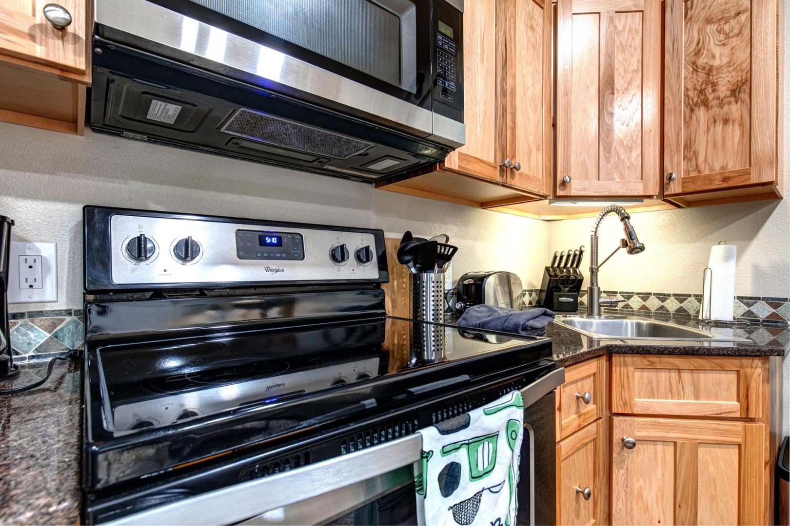 Kitchen: "Fully equipped with electric range, microwave, coffee maker, toaster, and sink."