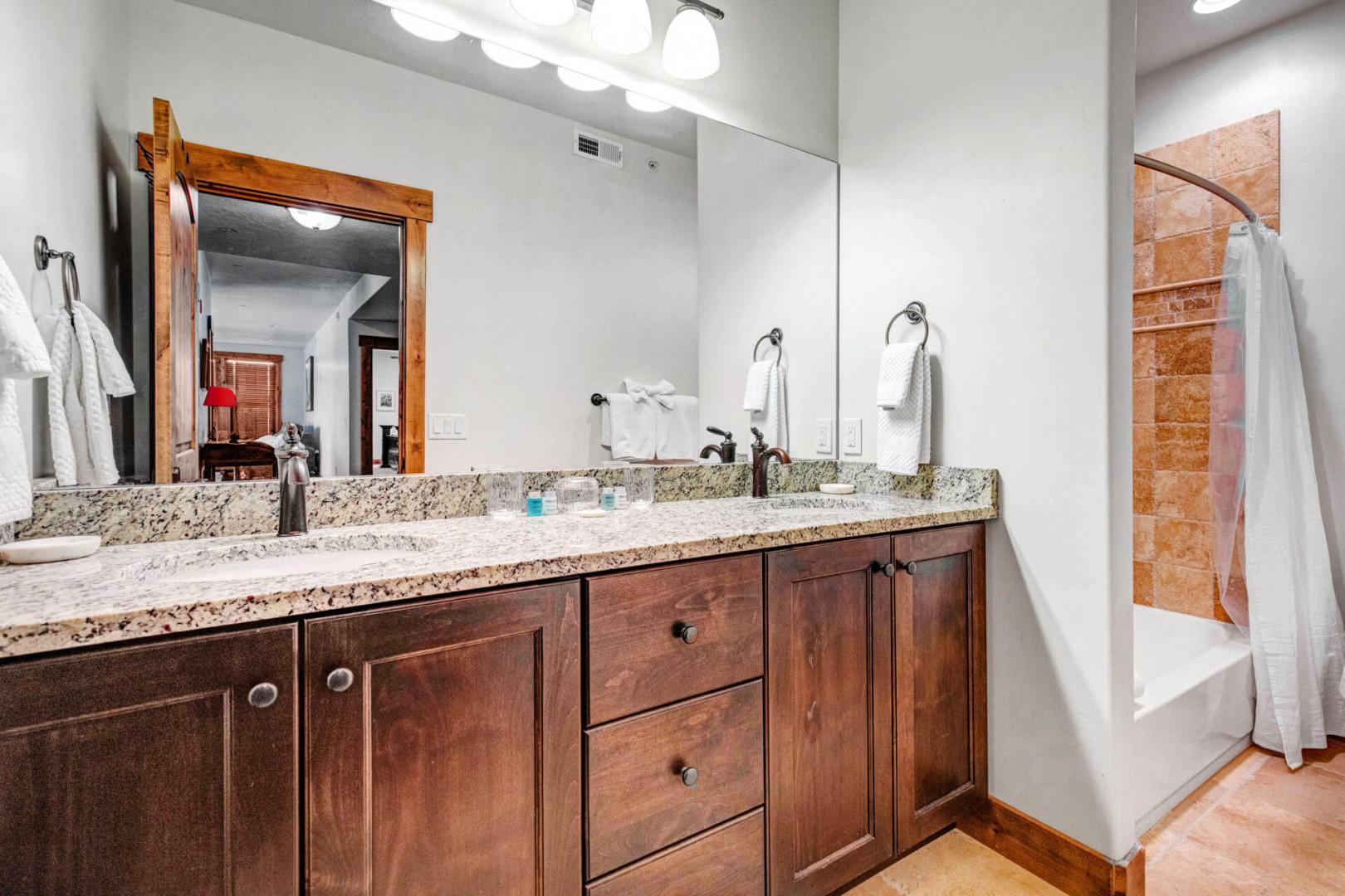 Step into your beautifully appointed bathroom with double vanity and granite countertops. Fluffy towels await as you unwind in the tiled tub-shower combo.