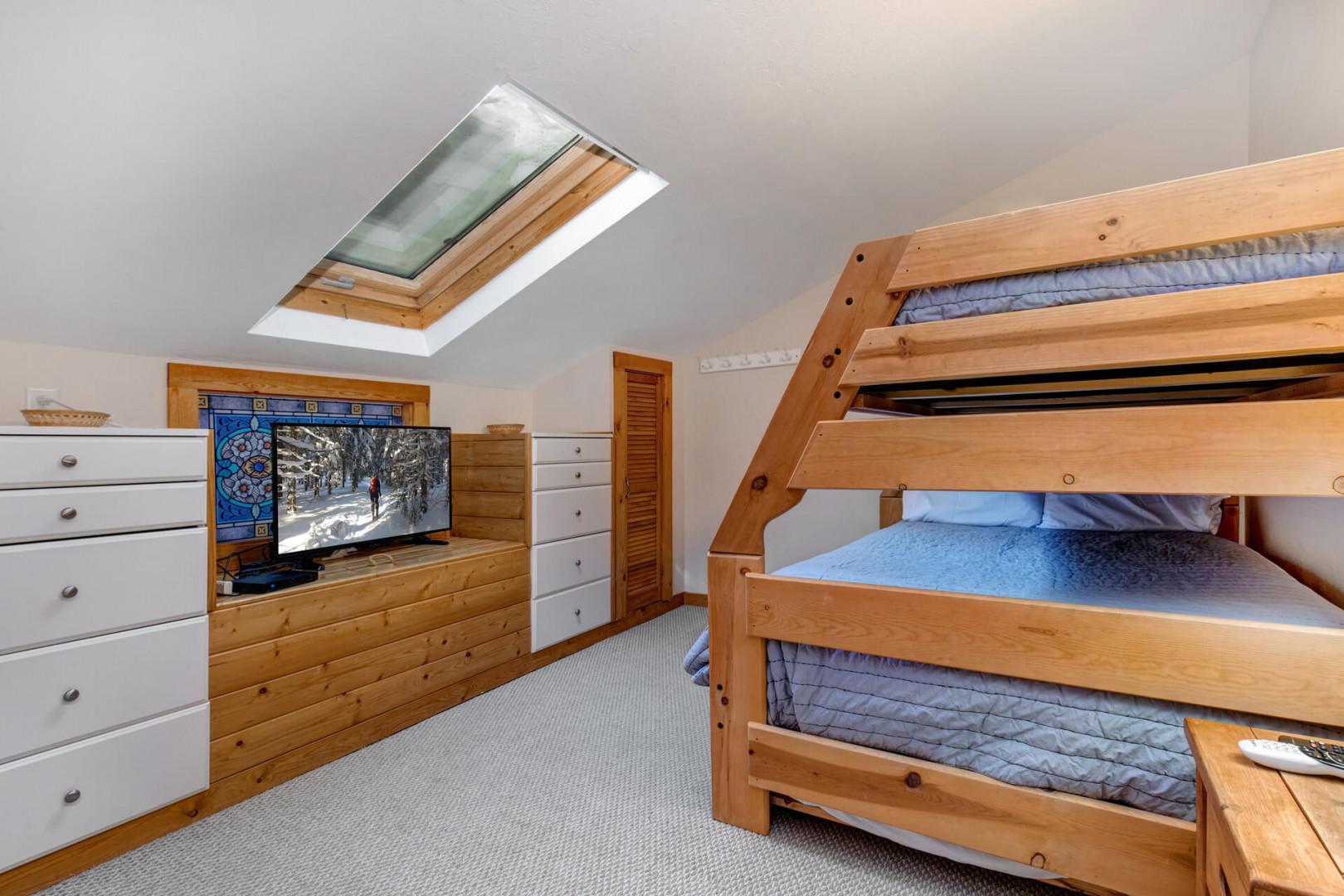 Bunk Bed "Cozy bunk bed with TV under the overhead window view.