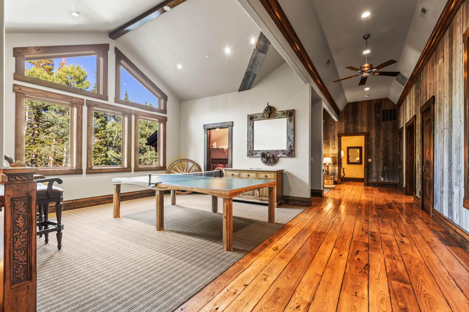 Table tennis by the windows, inviting a friendly competition.