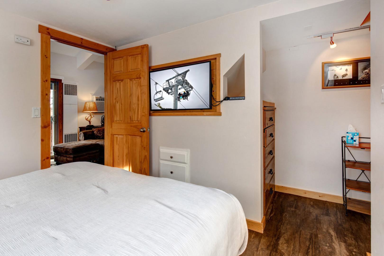 Cozy queen bed with a view, flanked by two lampshades.