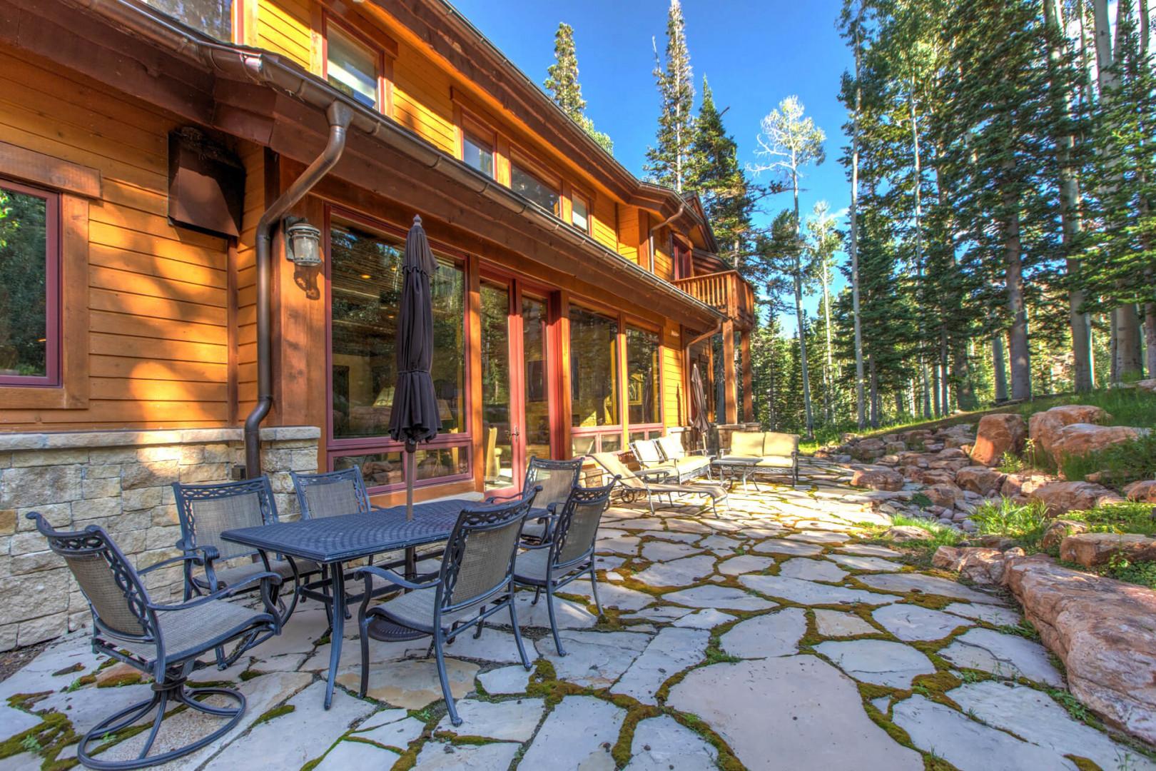 Alfresco dining awaits in this charming backyard oasis.