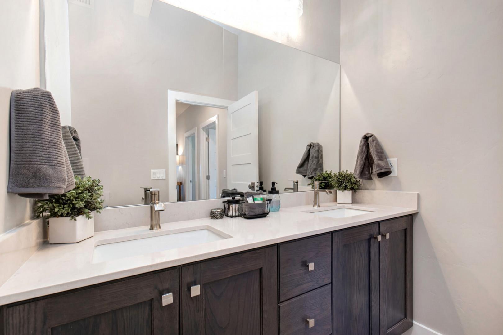 Reflective sink area with a sleek mirror, perfect for morning routines.