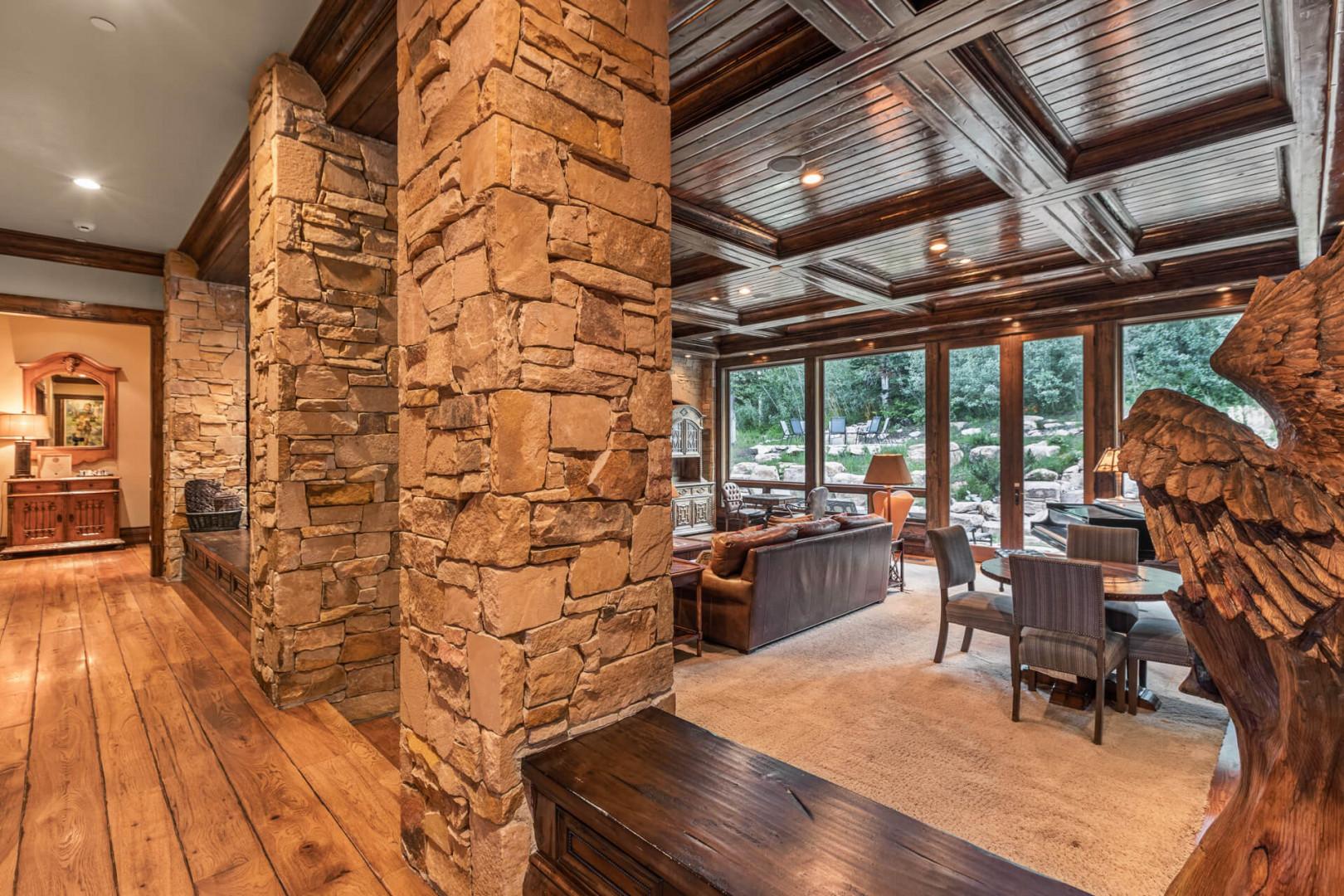 Cozy space with stylish sofa set, center table, and stoned beams.