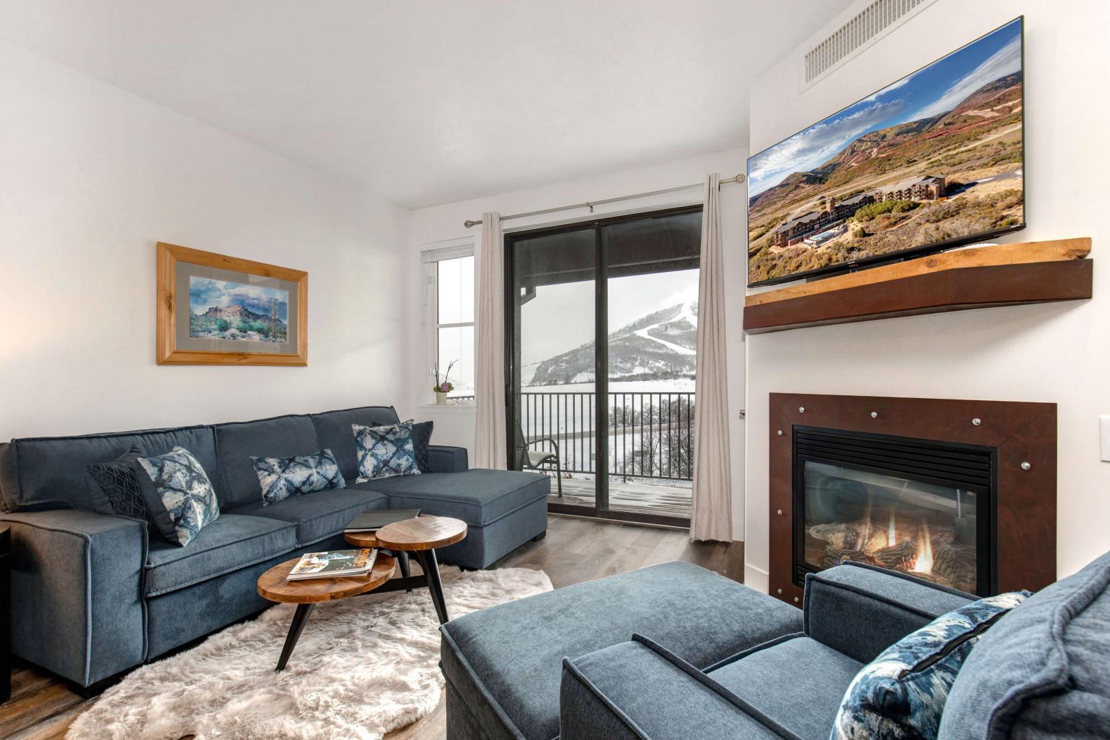 Stillwater #3011_08: Cozy sofa set by the fireplace, overlooking the serene balcony view.