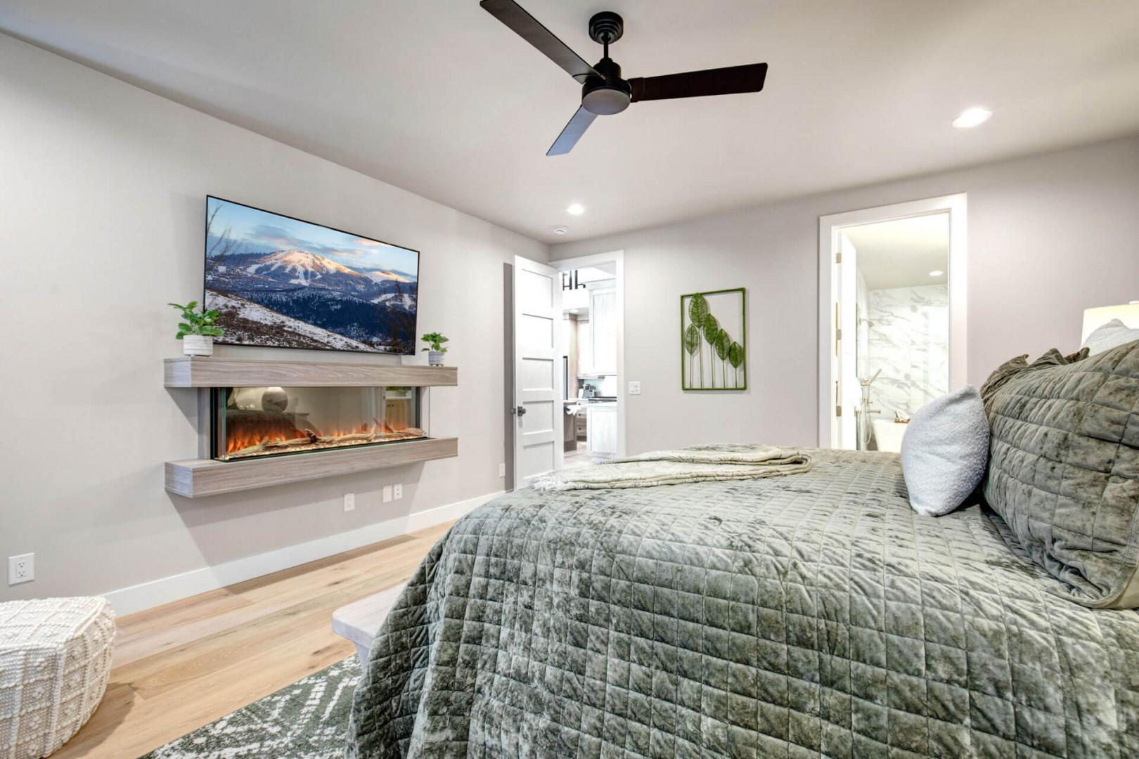 Sink into plush bedding with a cozy fireplace glowing nearby. Your private suite opens to a spa-inspired bath, with soft greenery adding a touch of serenity.