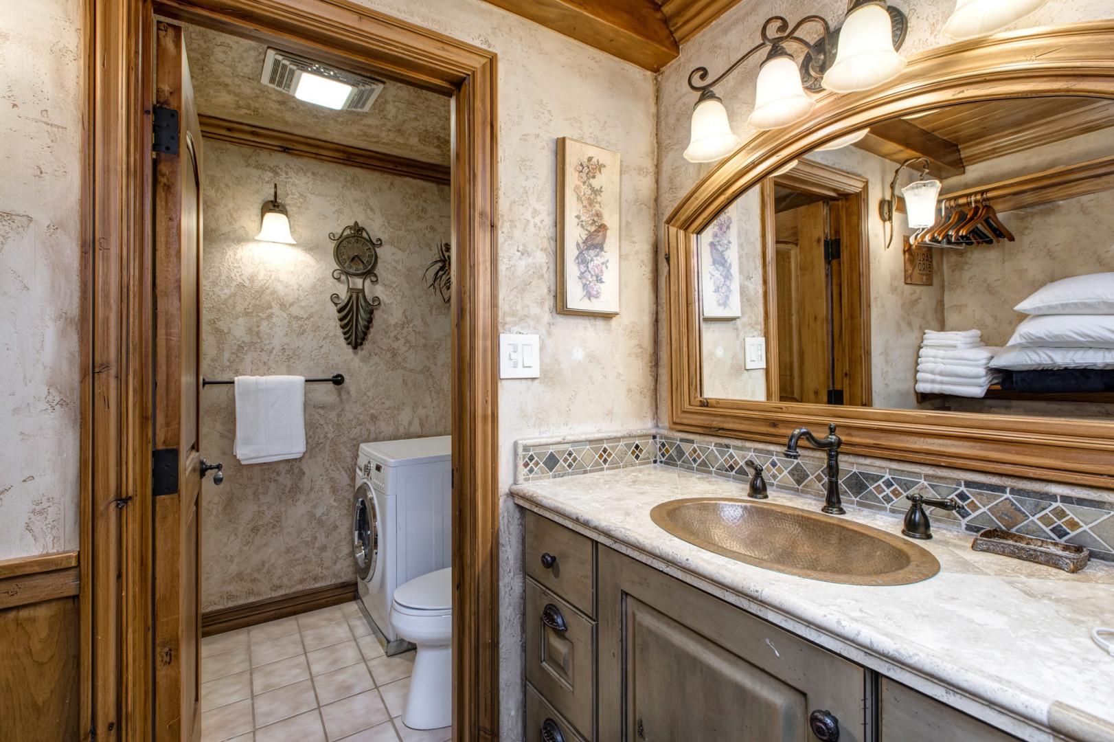 Reflective sink area with a sleek mirror, perfect for morning routines.