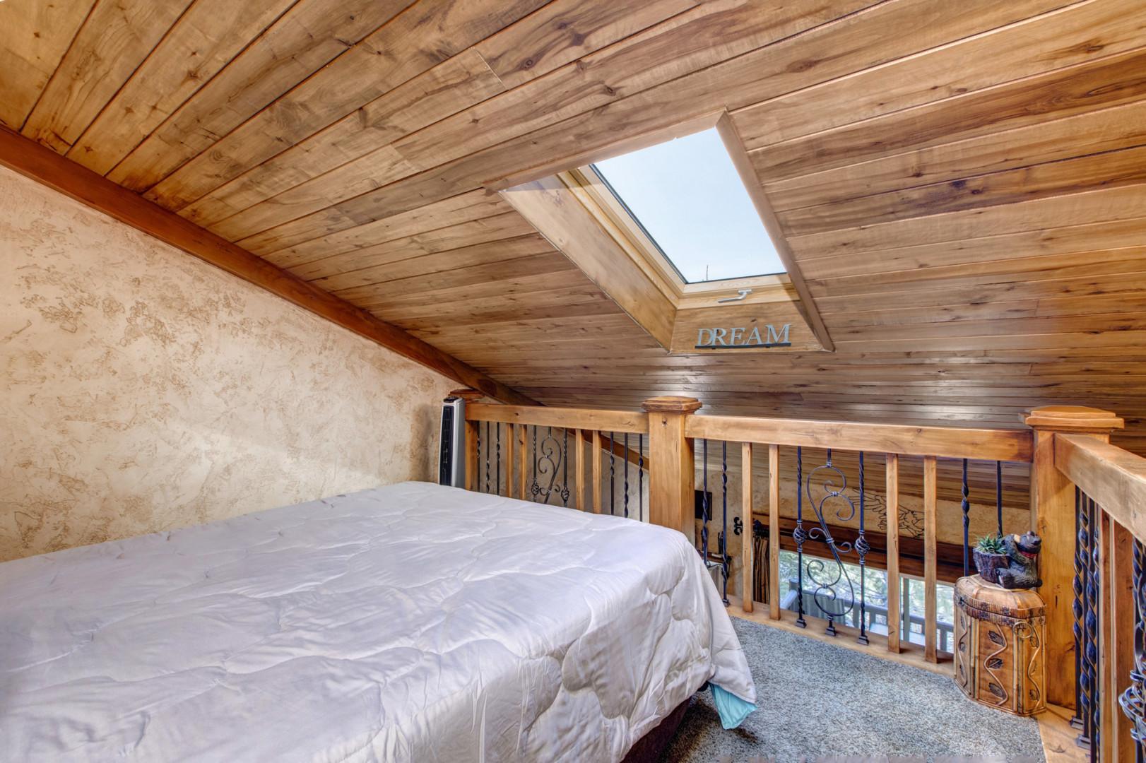 Loft: "Cozy queen bed tucked away under the eaves."