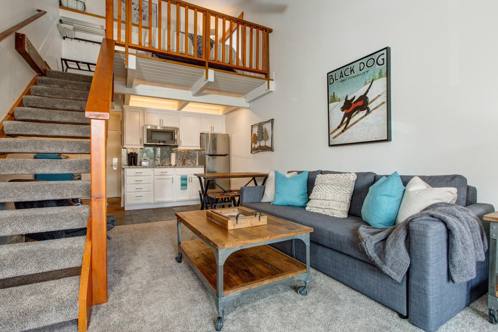 Cozy space with sofa bed, dining area, and kitchenette.